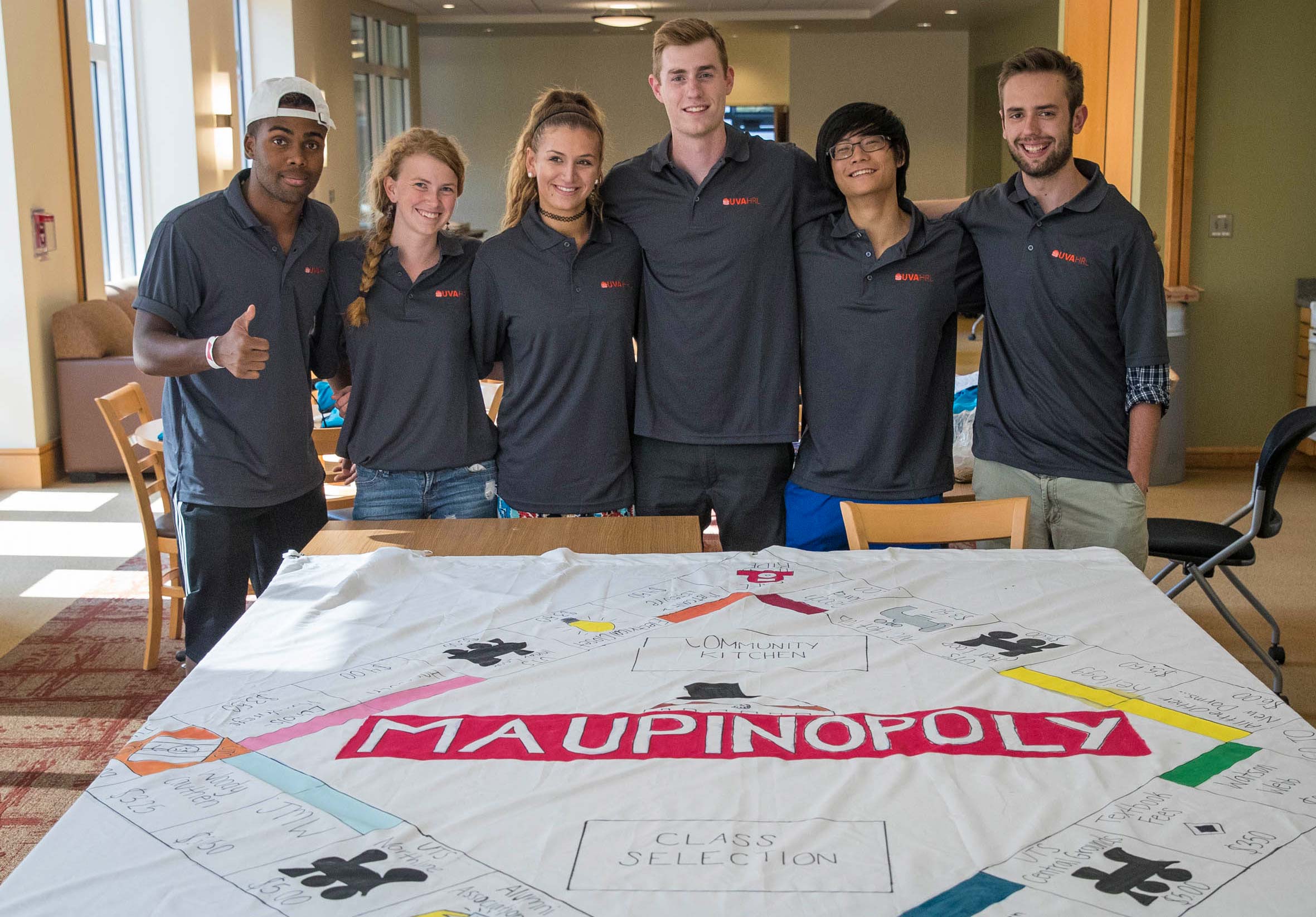 Students stand in front of a huge Maupinopoly board