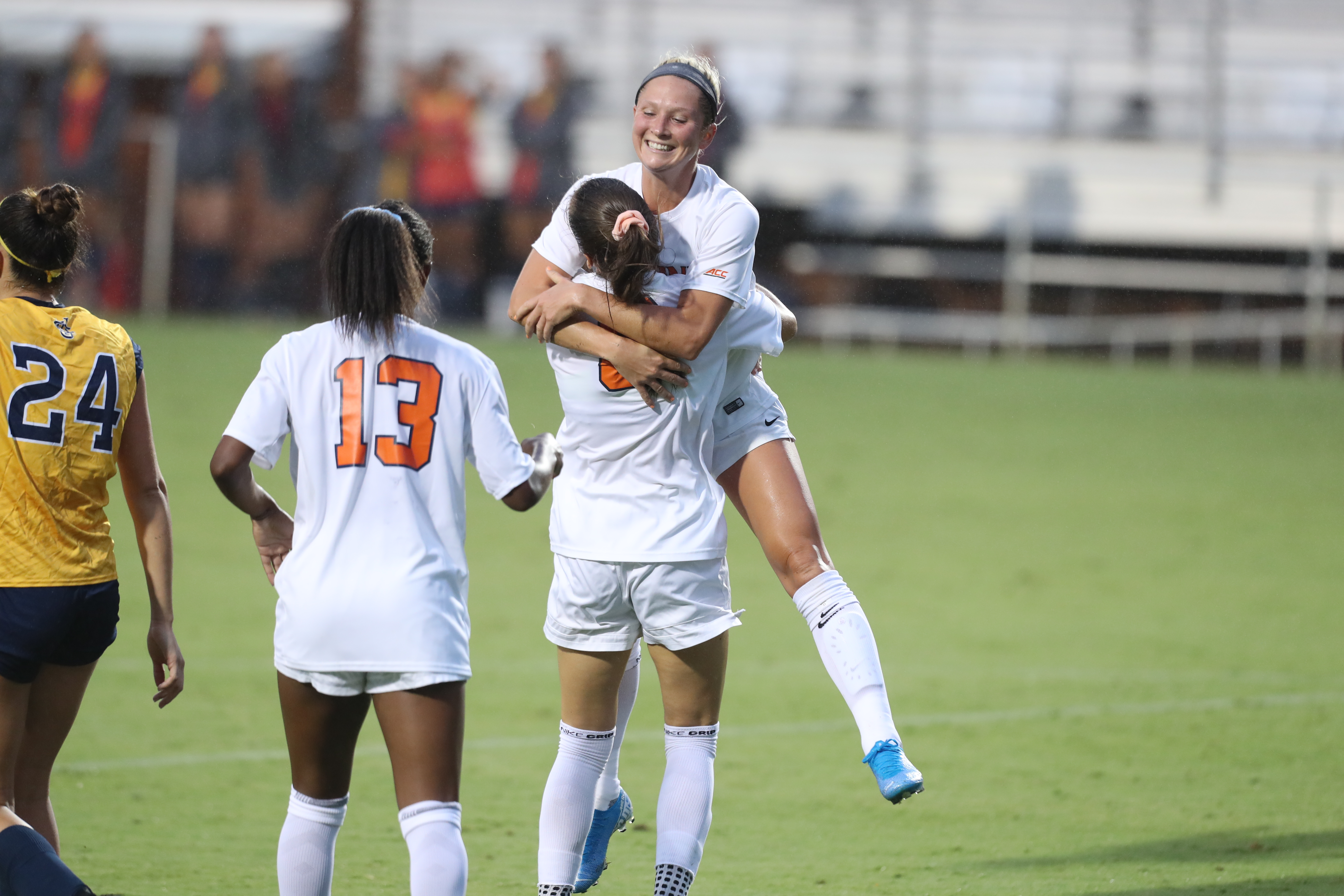 UVA's womens soccer teammate jumps into the arms of another teammate during the game