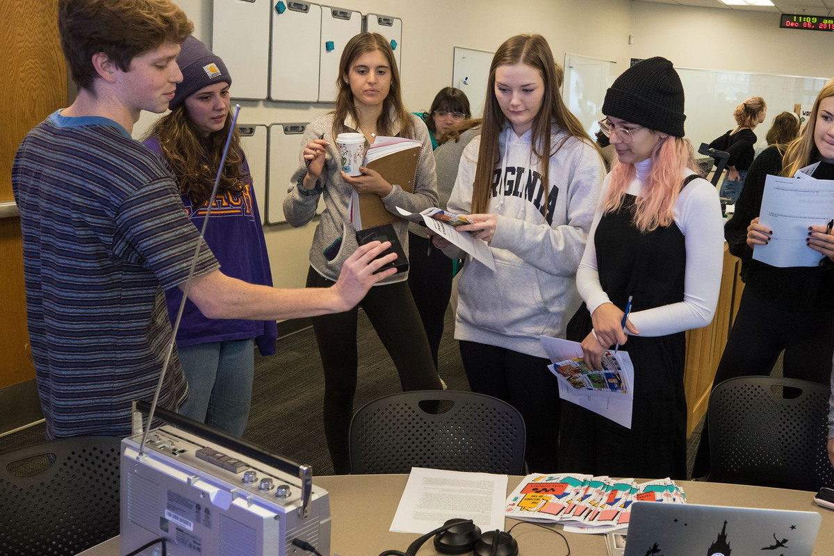 Group of students listening to a Walkman