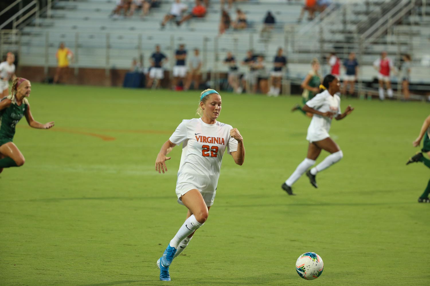 Meghan McCool kicking the soccer ball down field during a game