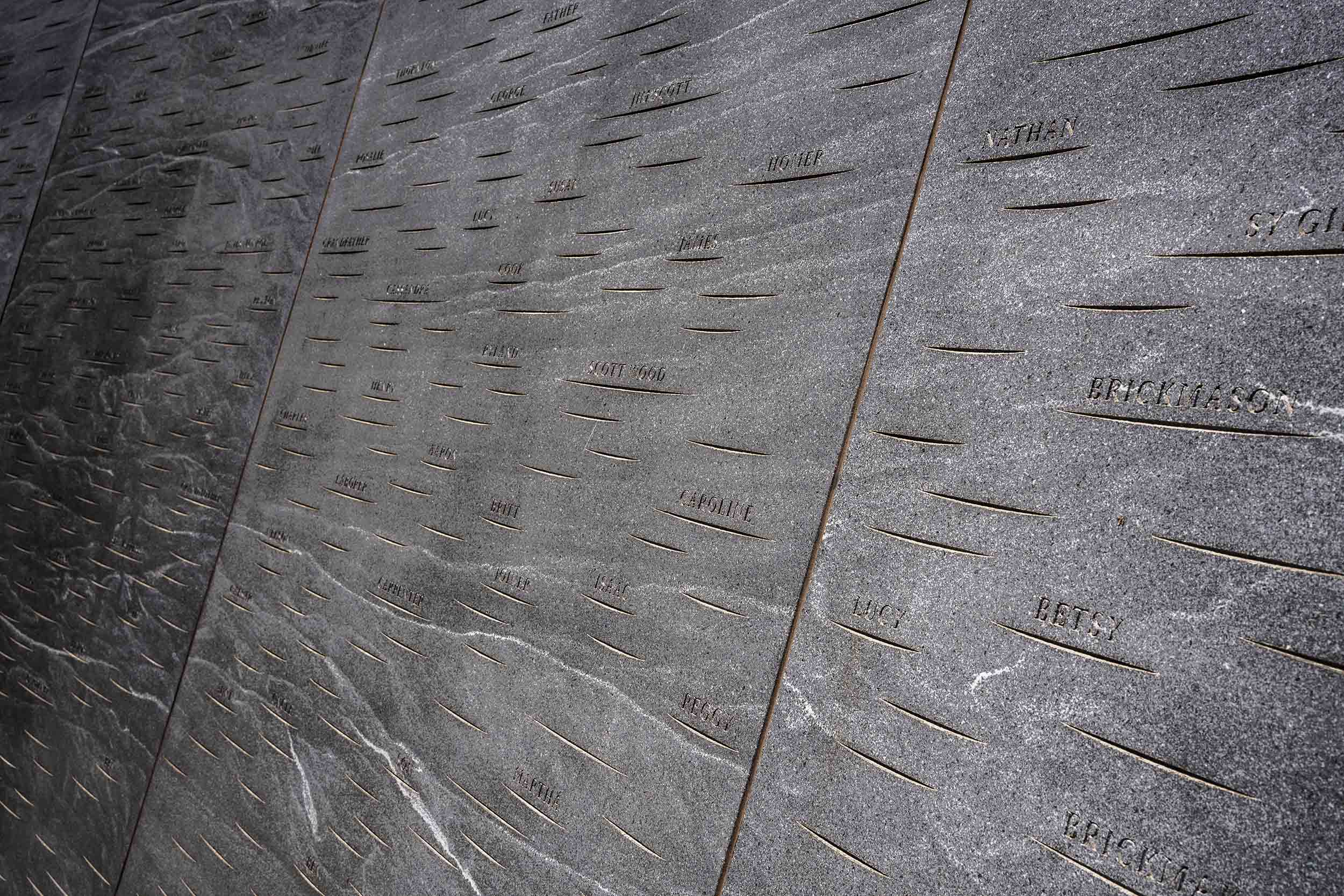 Up close view of names on the memorial of enslaved laborers