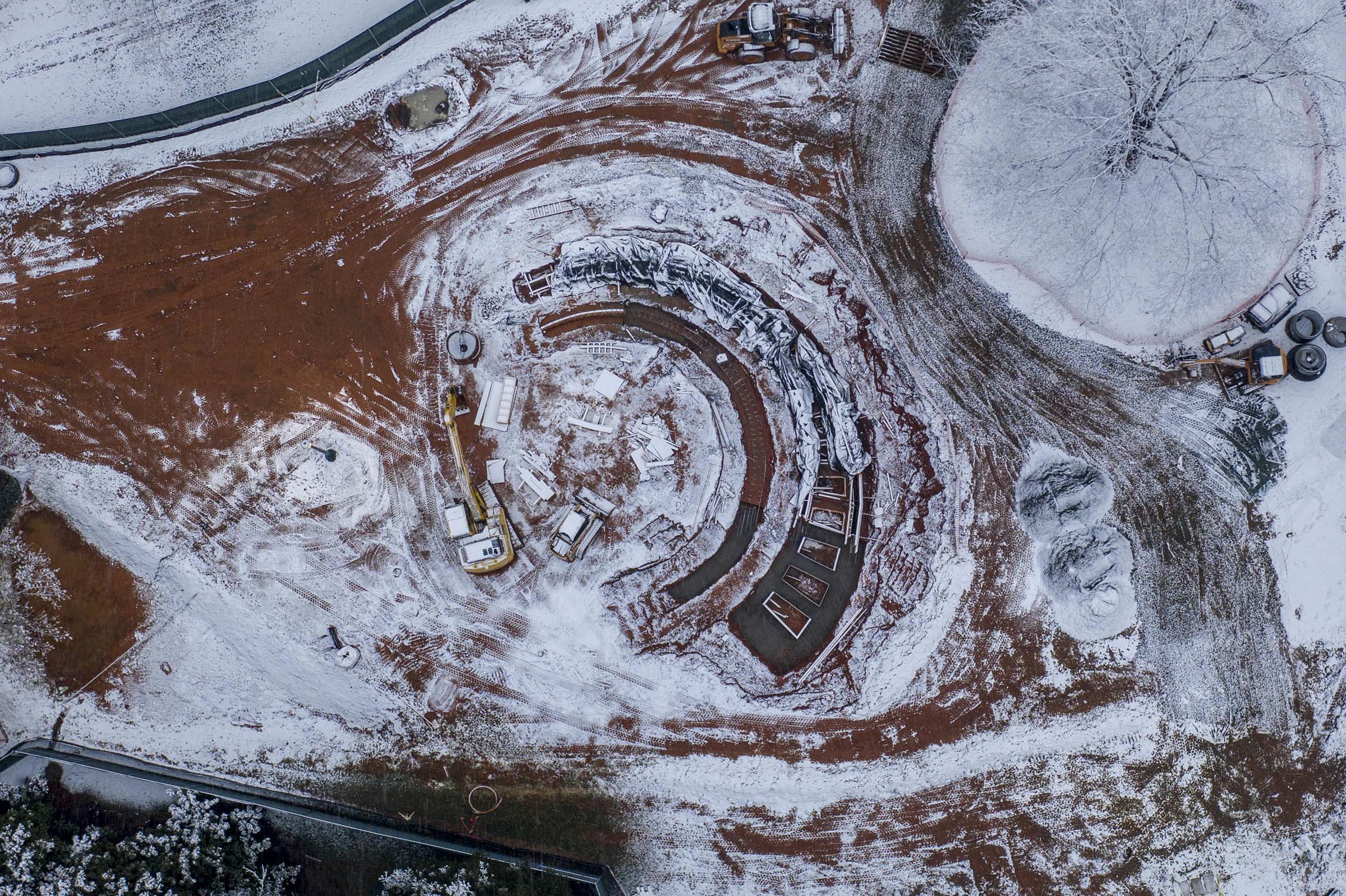 Aerial view of the Memorial for Enslaved Laborers memorial covered in snow as it is being constructed
