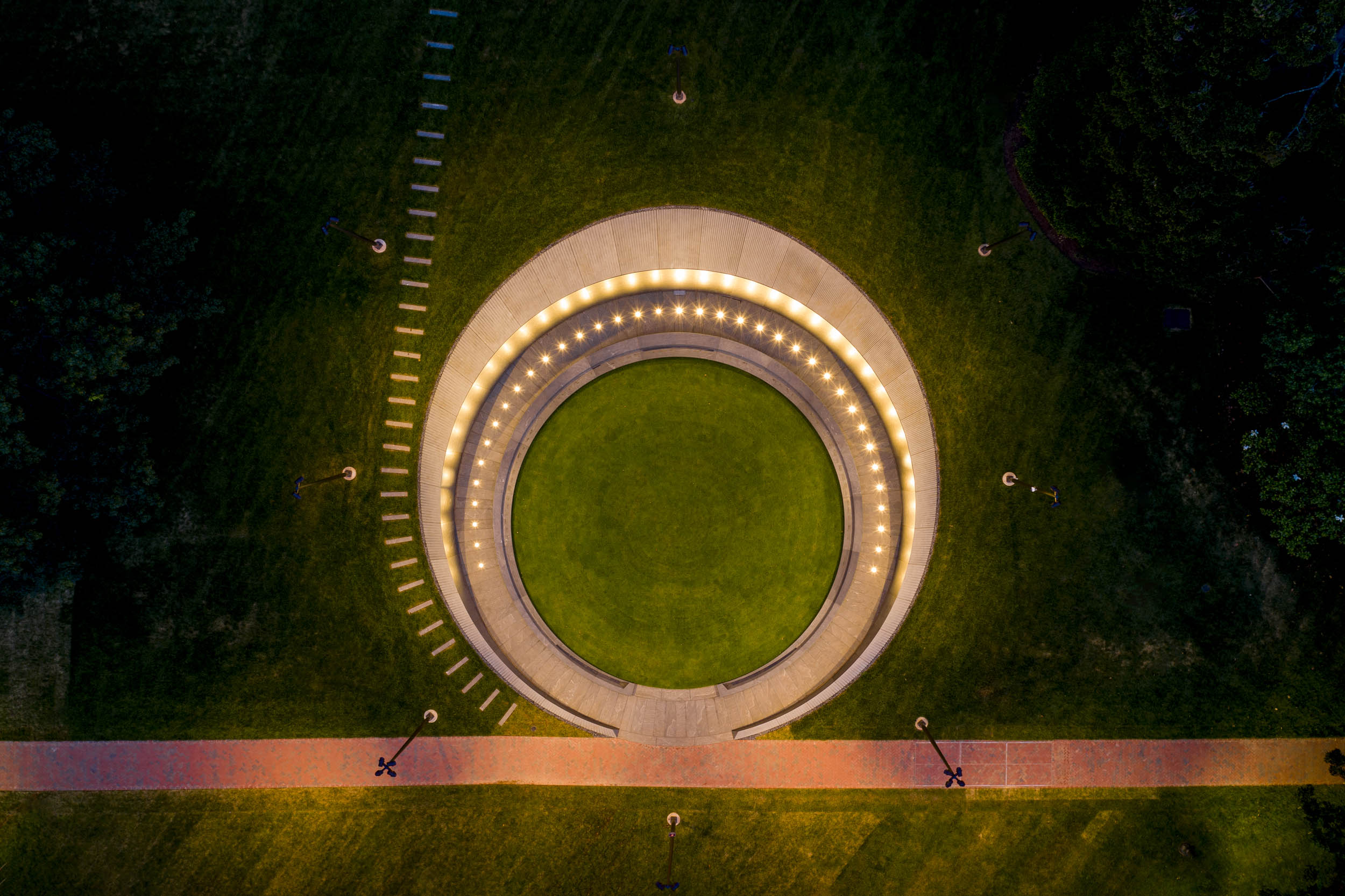 Aerial view of the Memorial for Enslaved Laborers memorial lit up by lights on top and around the memorial