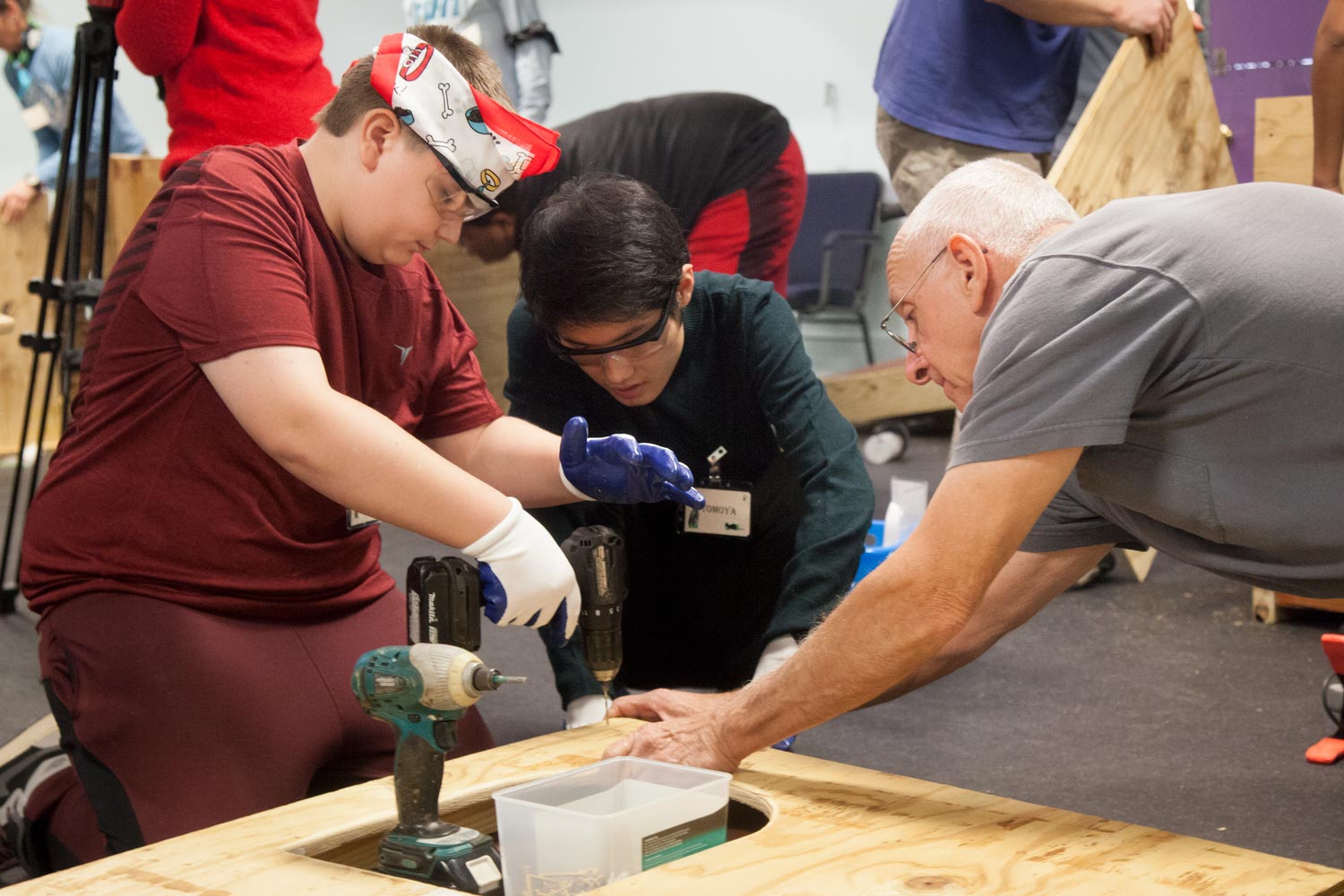 students work together to build a wooden structure