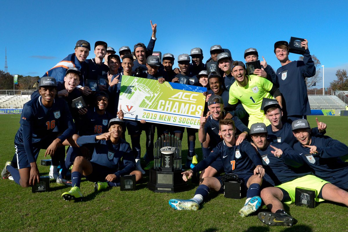  George Gelnovatch with UVA's mens soccer team pose for a group photo with their trophy