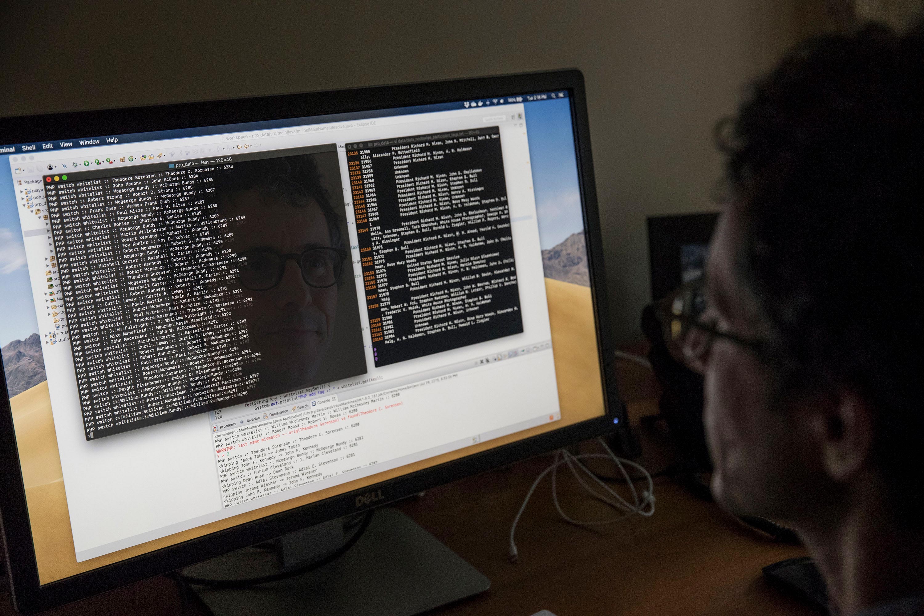 Efron looking at code on a computer screen