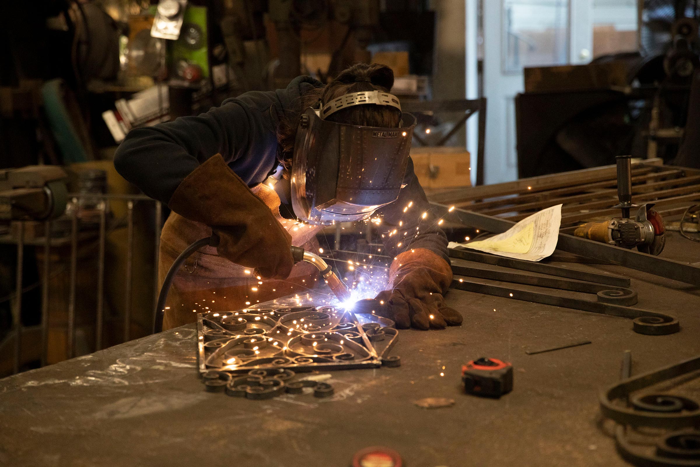 Mira Du Plessis welding a metal structure