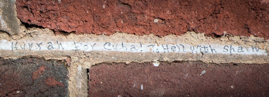 P.C. Massie and J.R. Kean (top) signed their names on the mortar between bricks when they were students at Monroe Hill. Students also left messages about the Spanish-American war (bottom).