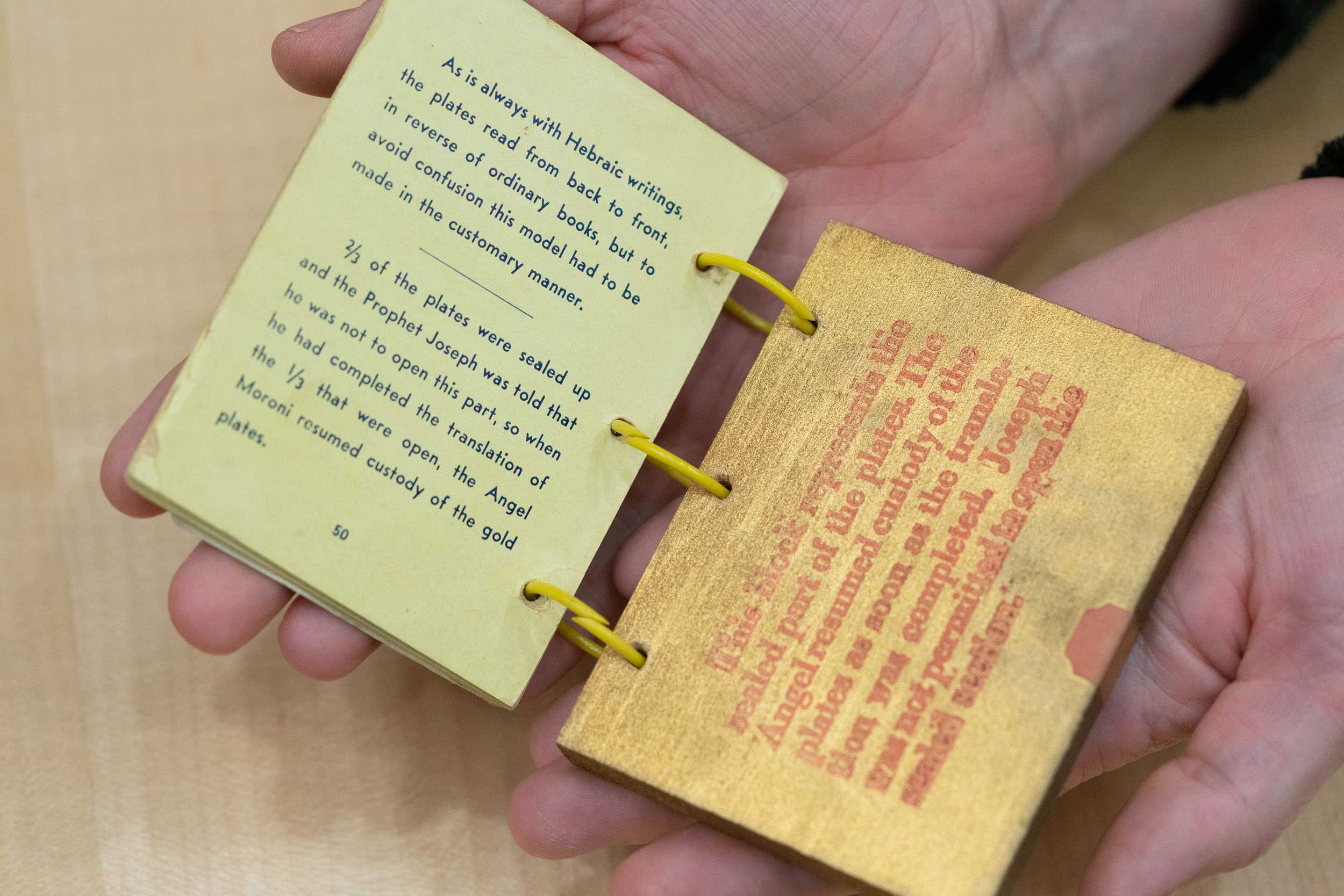 Mini book opened in a persons hands