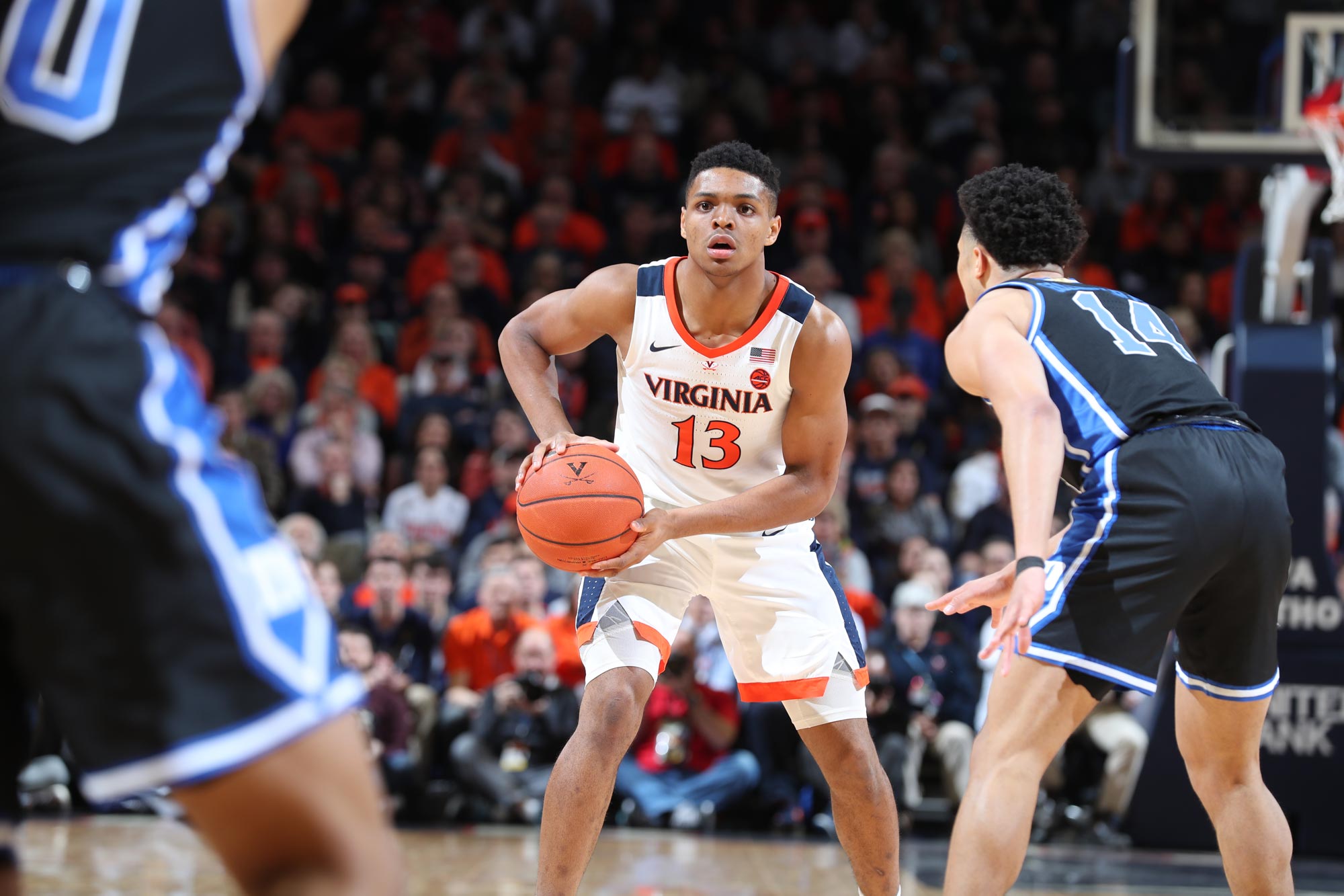 Casey Morsell prepares to pass the basketball to a teammate as he is guarded by a defender