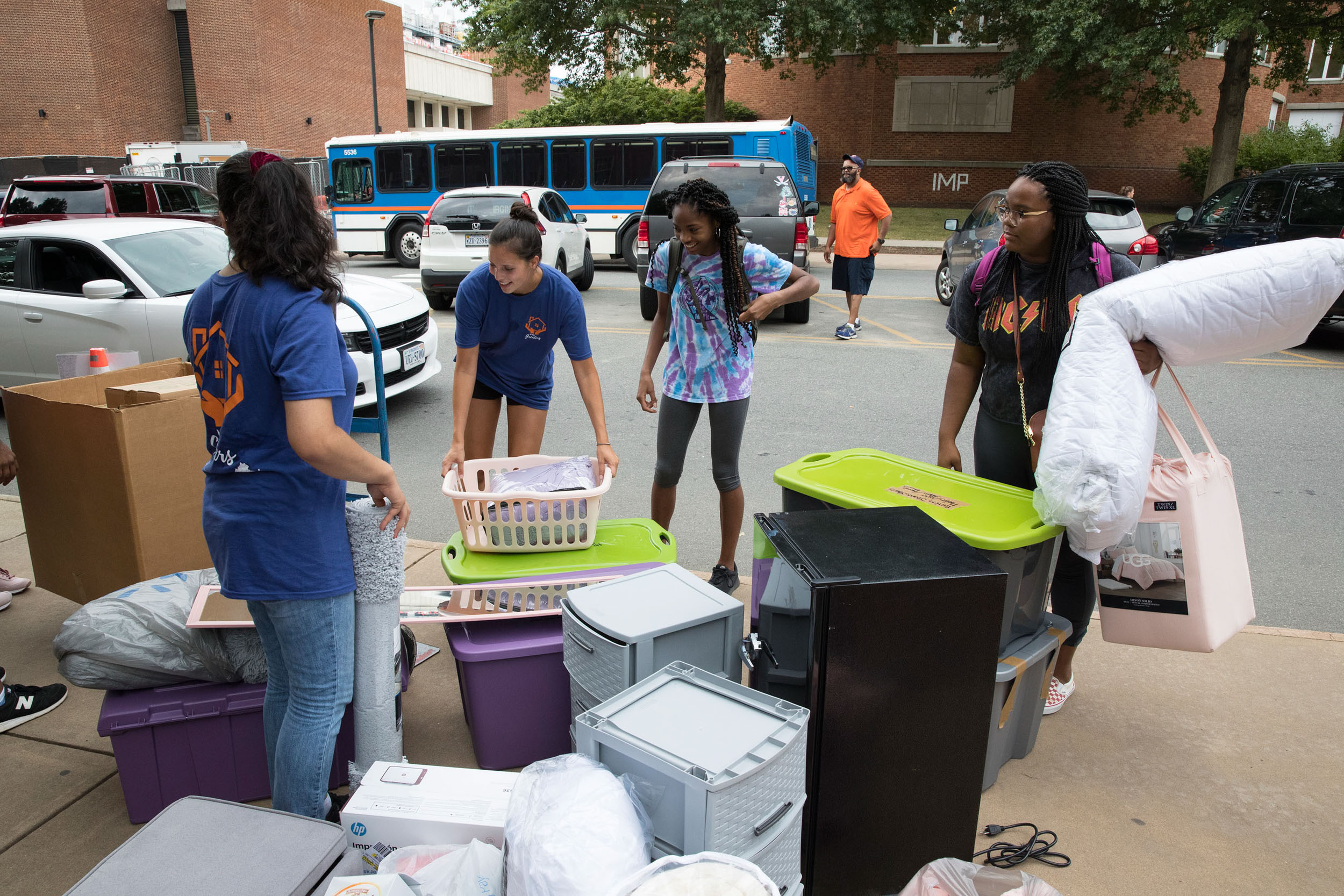 Taylor Gibson, far right, stands amid two carloads of belongings 