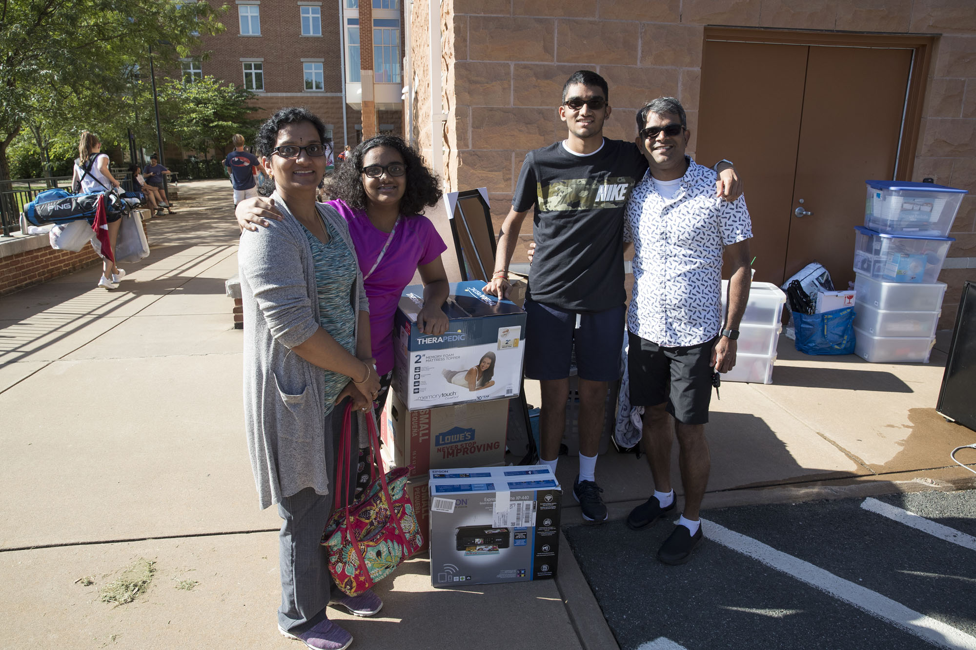 Teja Suvarna stands with his parents and sister as they stand next to a stack of his belongings