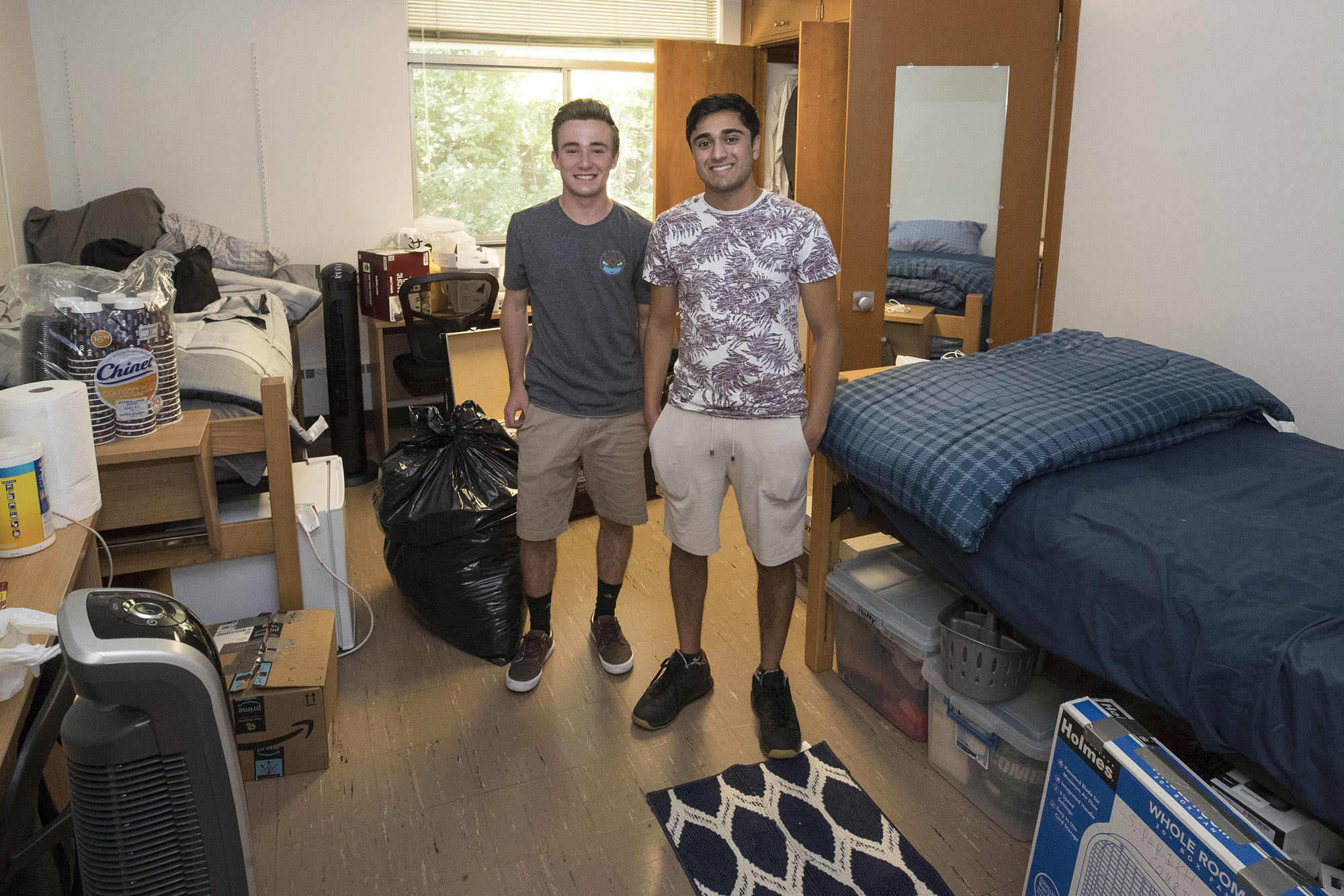 Sahil Parikh and Patrick Morris stand in their room for a picture