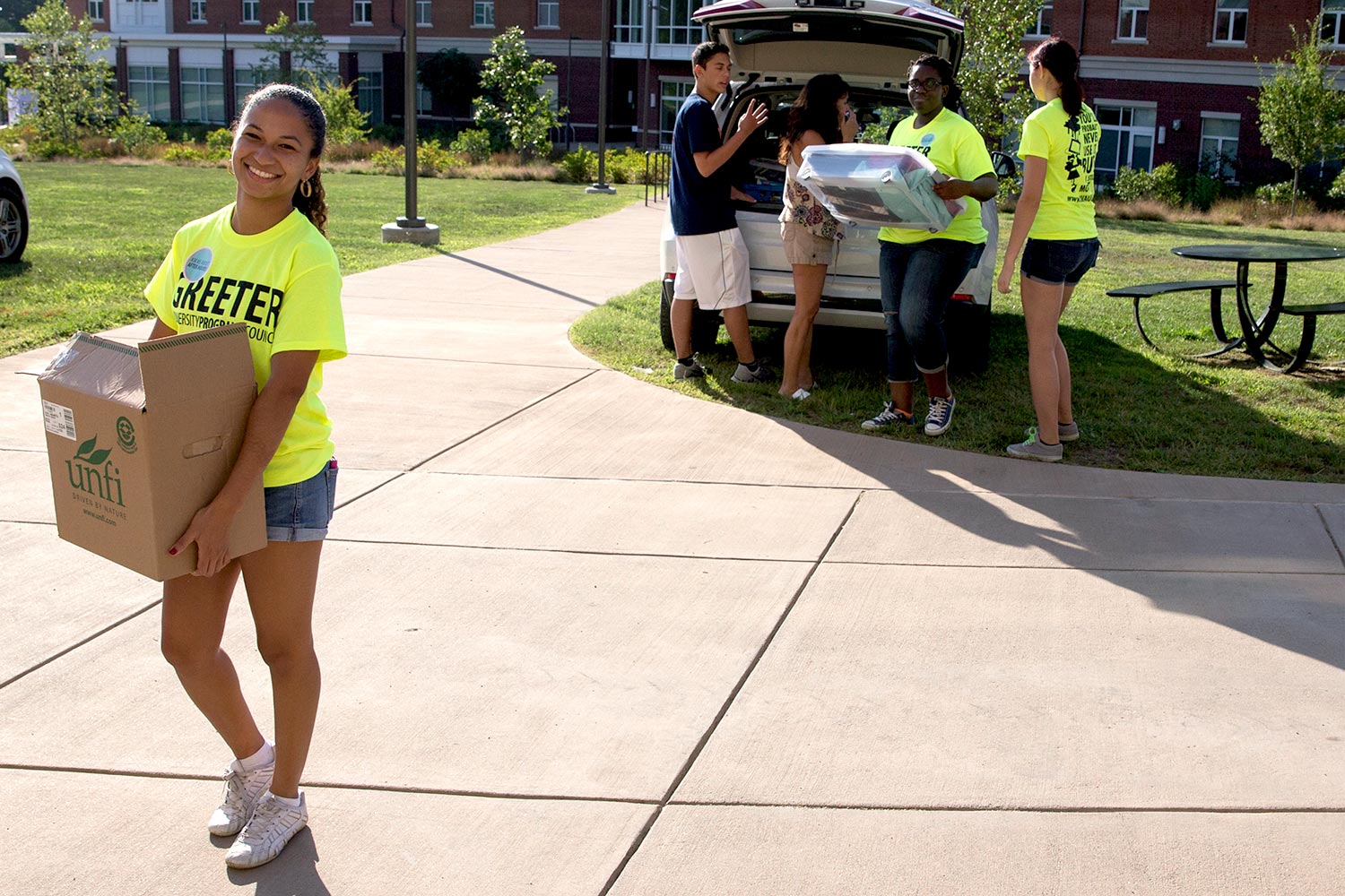 Students carrying their belongings into their dorms