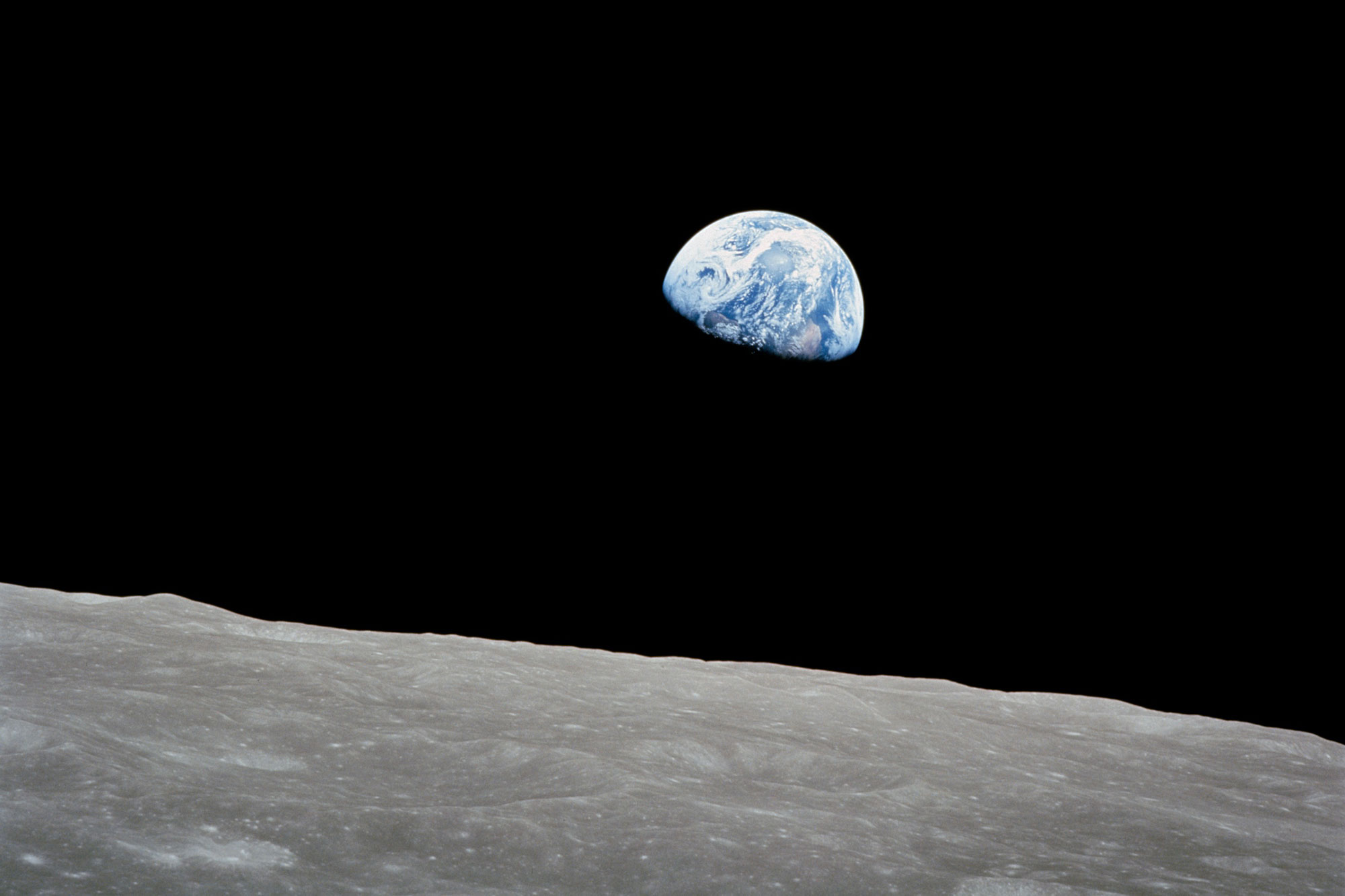 Photo of the Earth rising over the moon