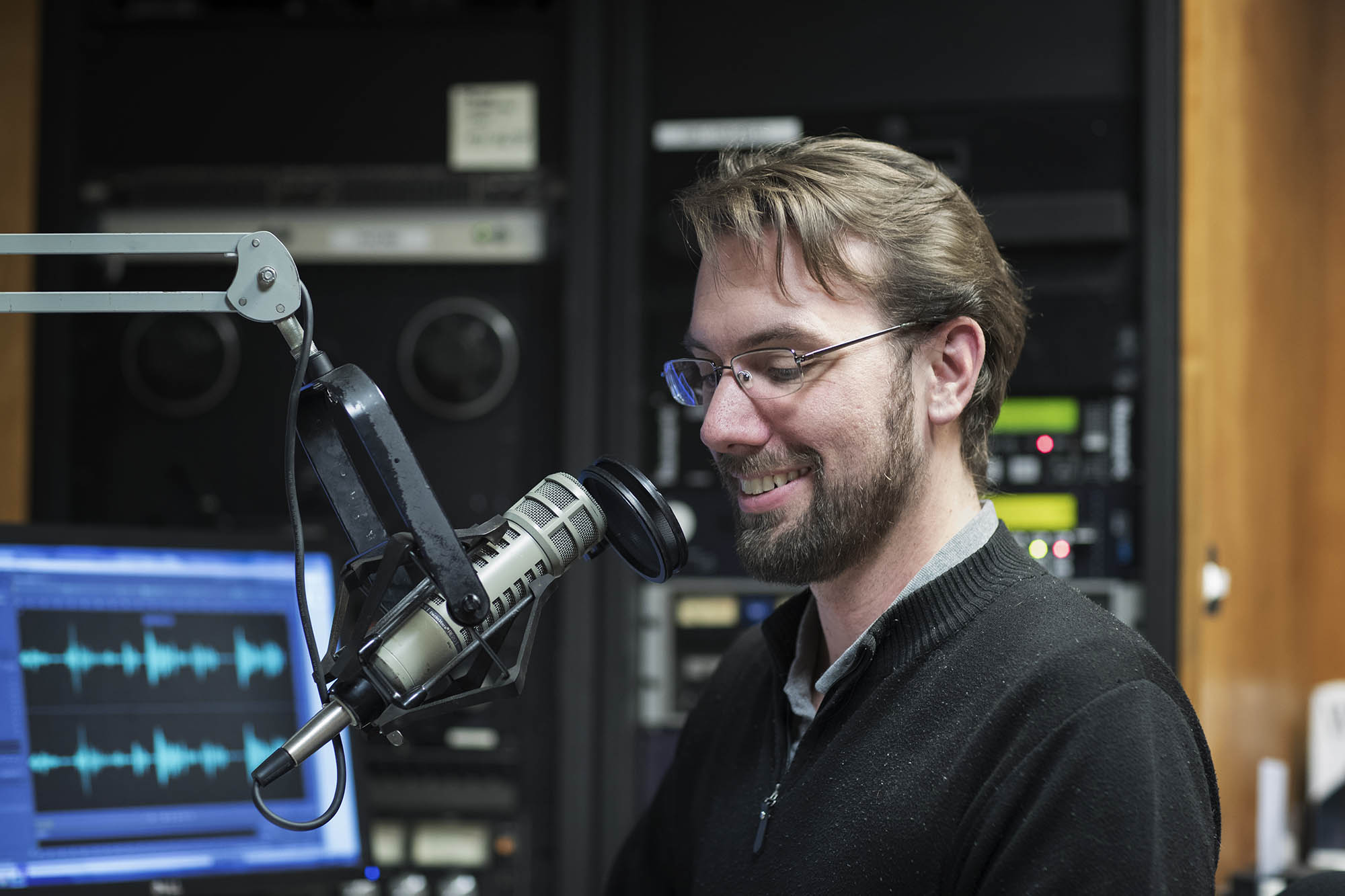 Nathan Moore speaking into a microphone for WTJU's radio programs
