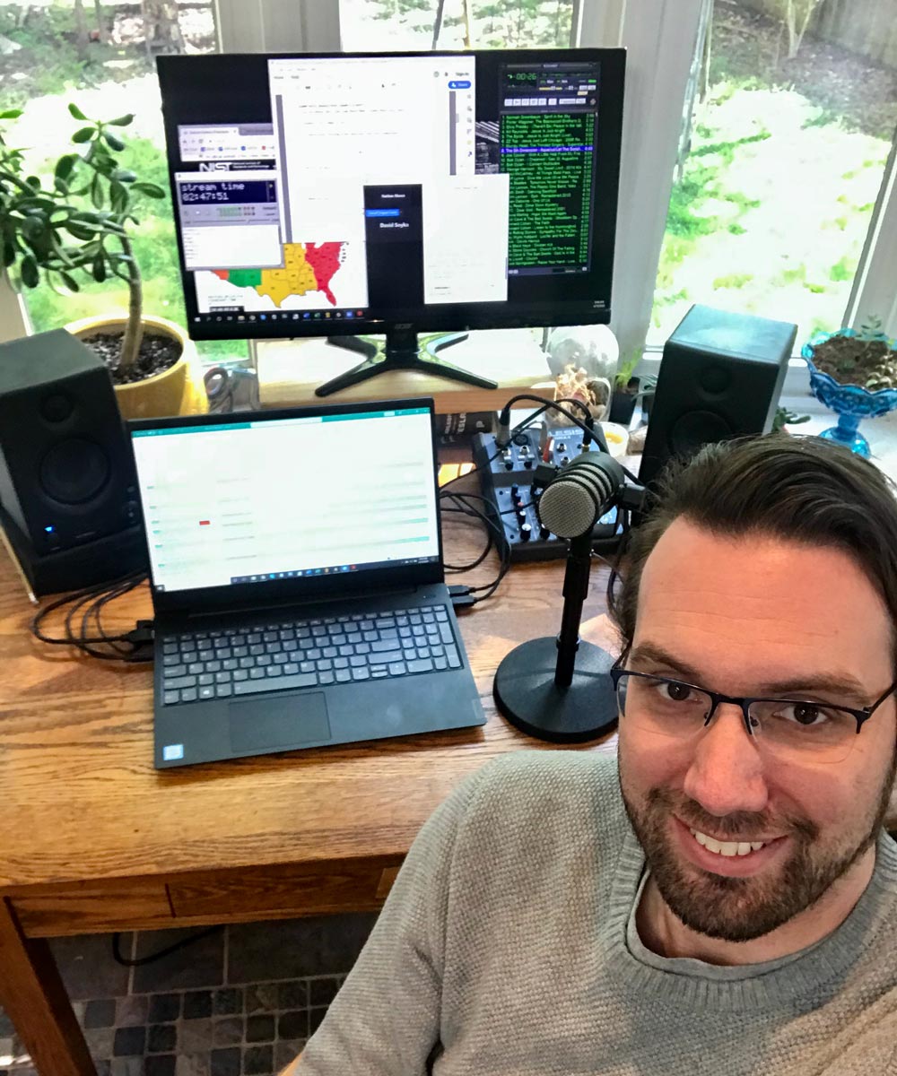 Selfie of Nathan Moore sitting at his radio station desk