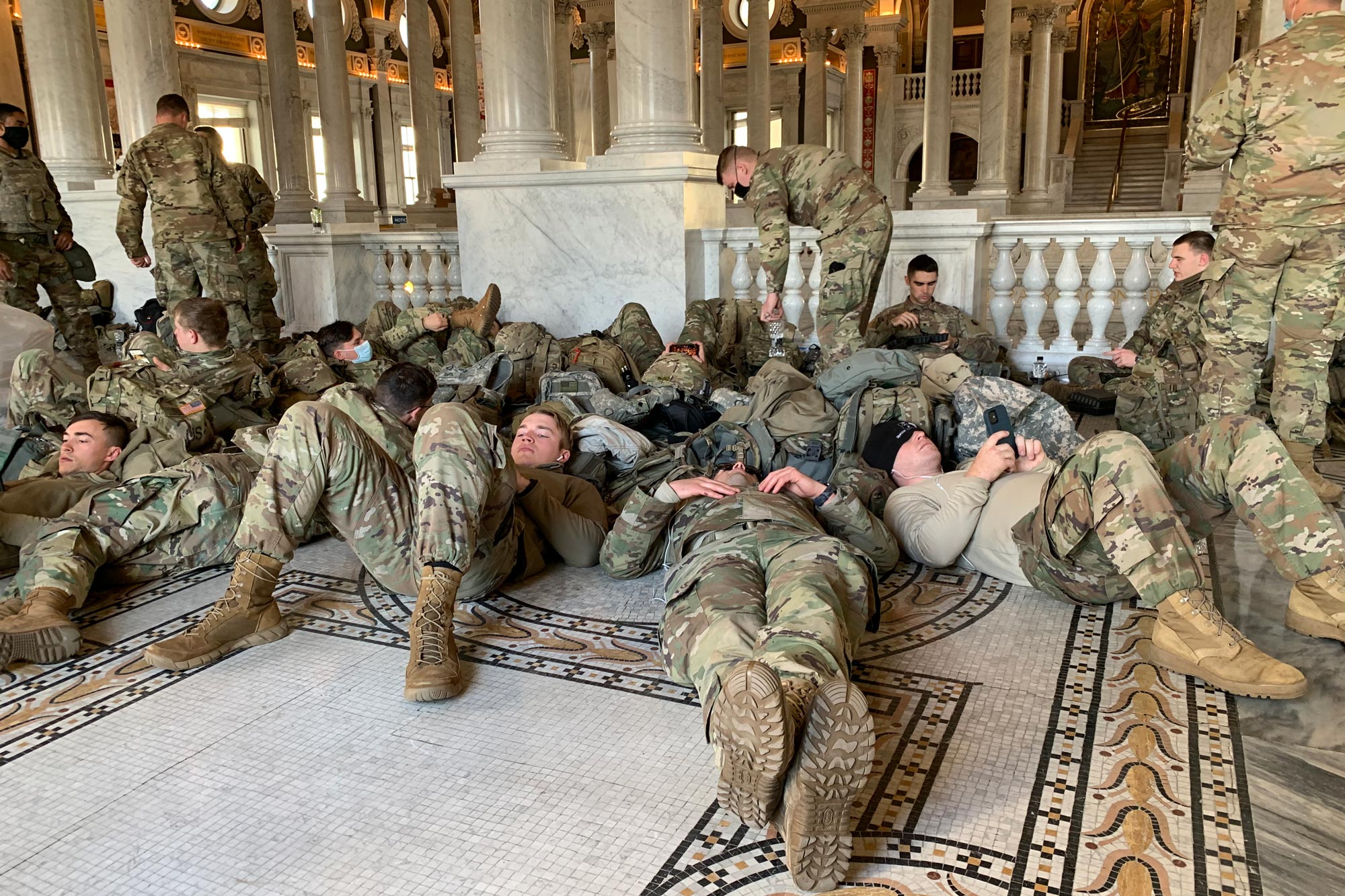 US Service men sitting and laying on the ground of the Capitol