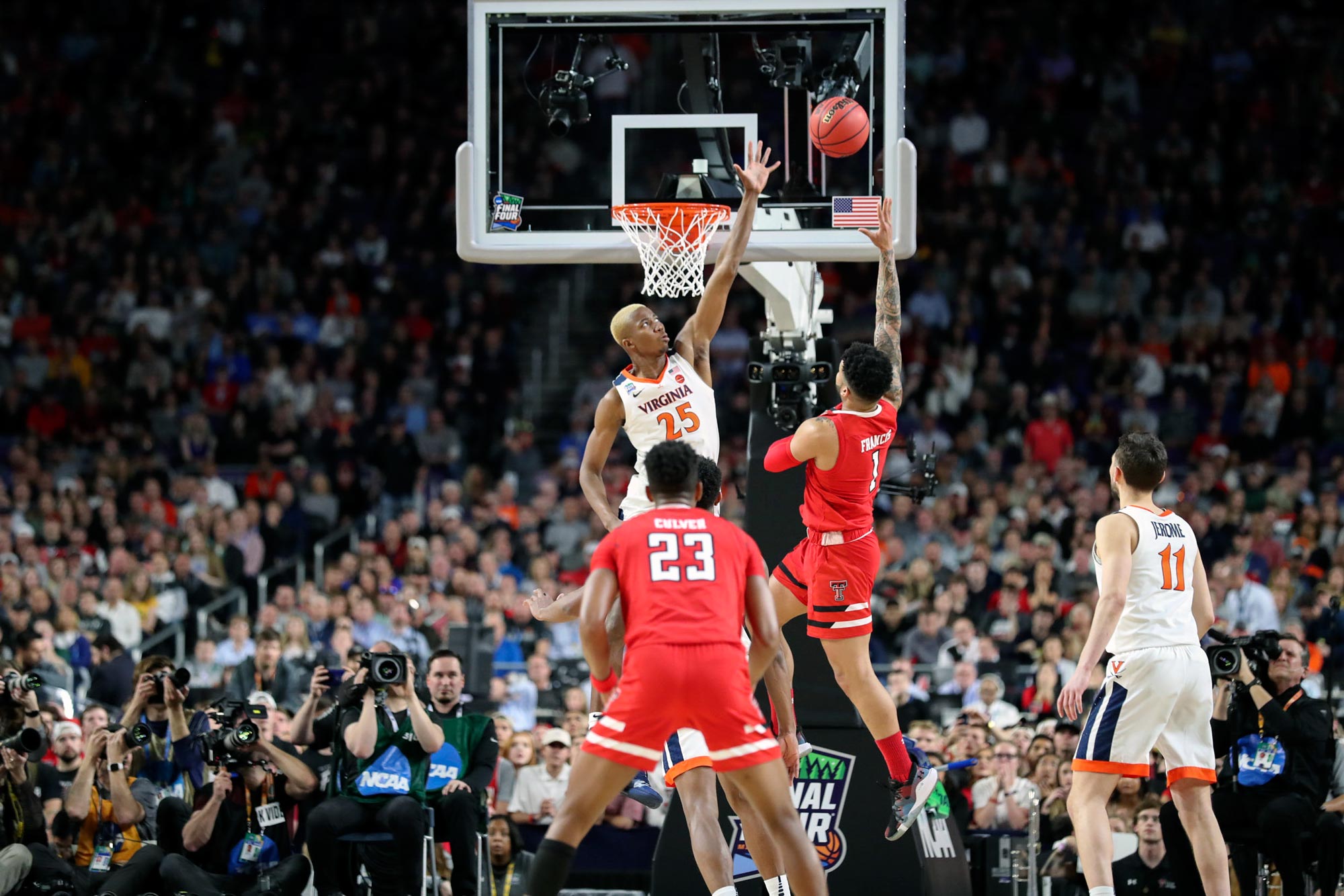 Mamadou Diakite jumps up to block a layup from an opponent