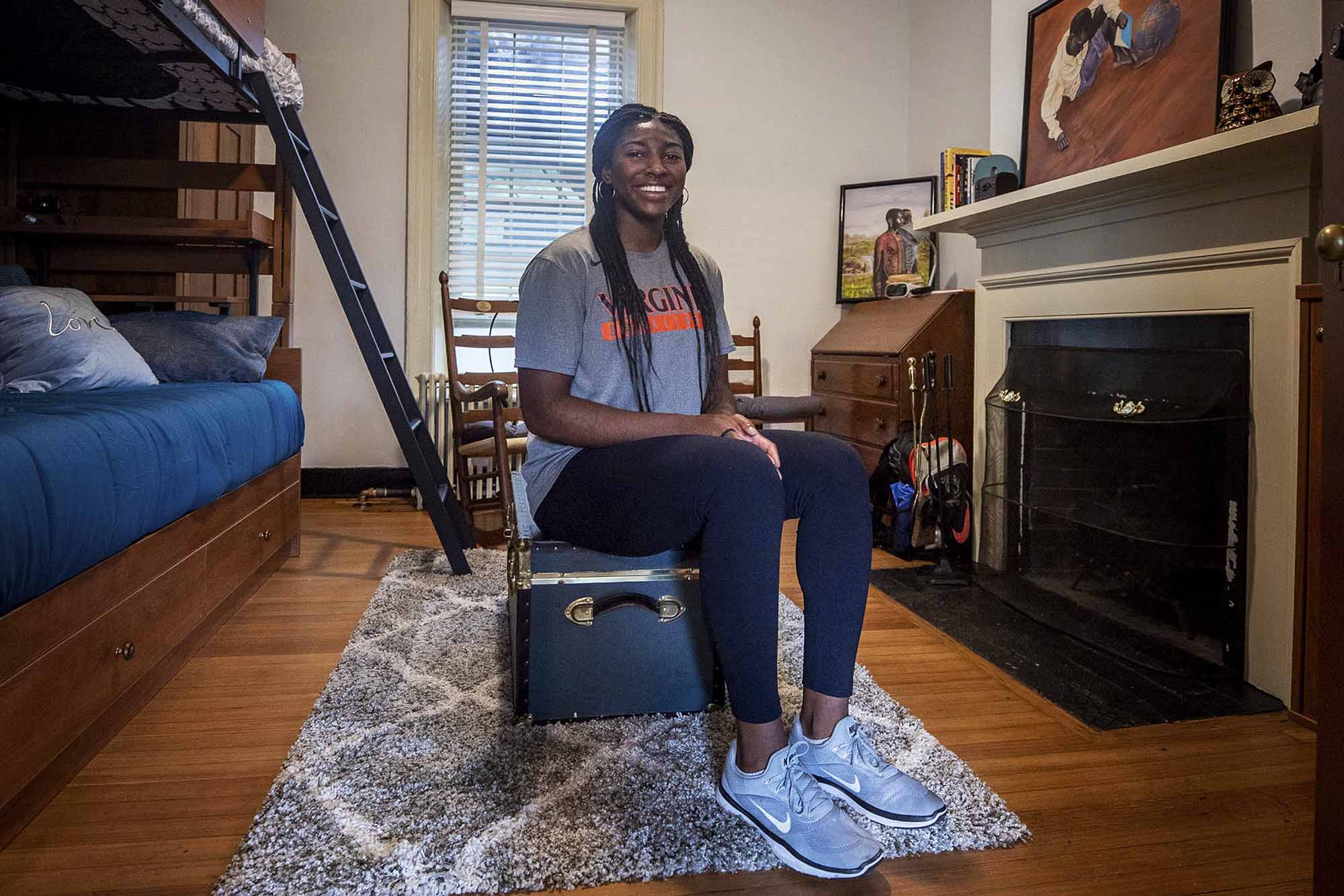 Willoughby seating on a chest in her Lawn Room