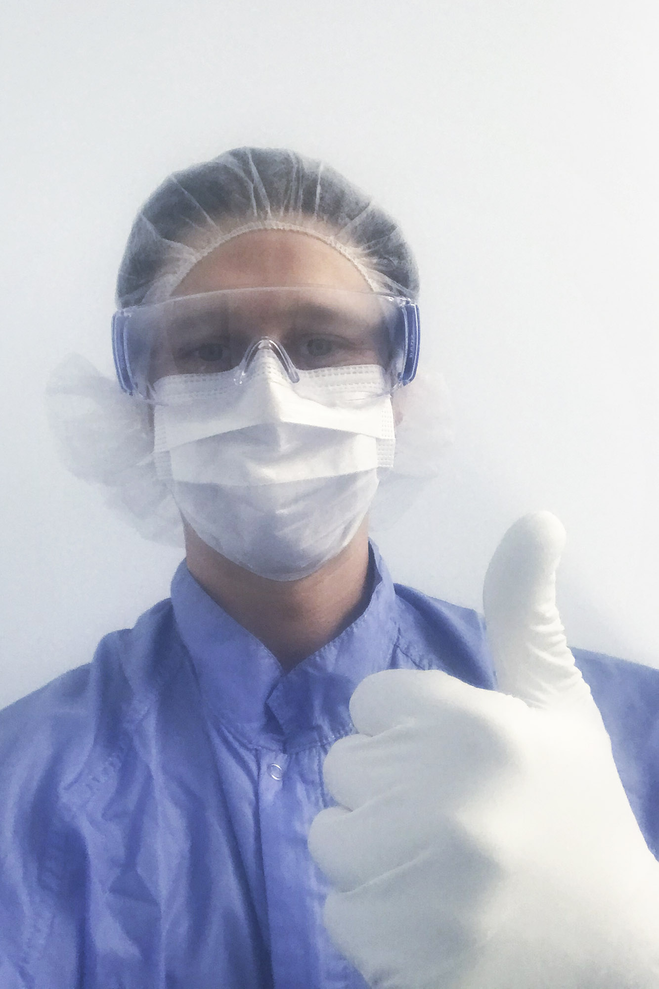 Nick Seyler gives thumbs up while wearing full personal protective equipment