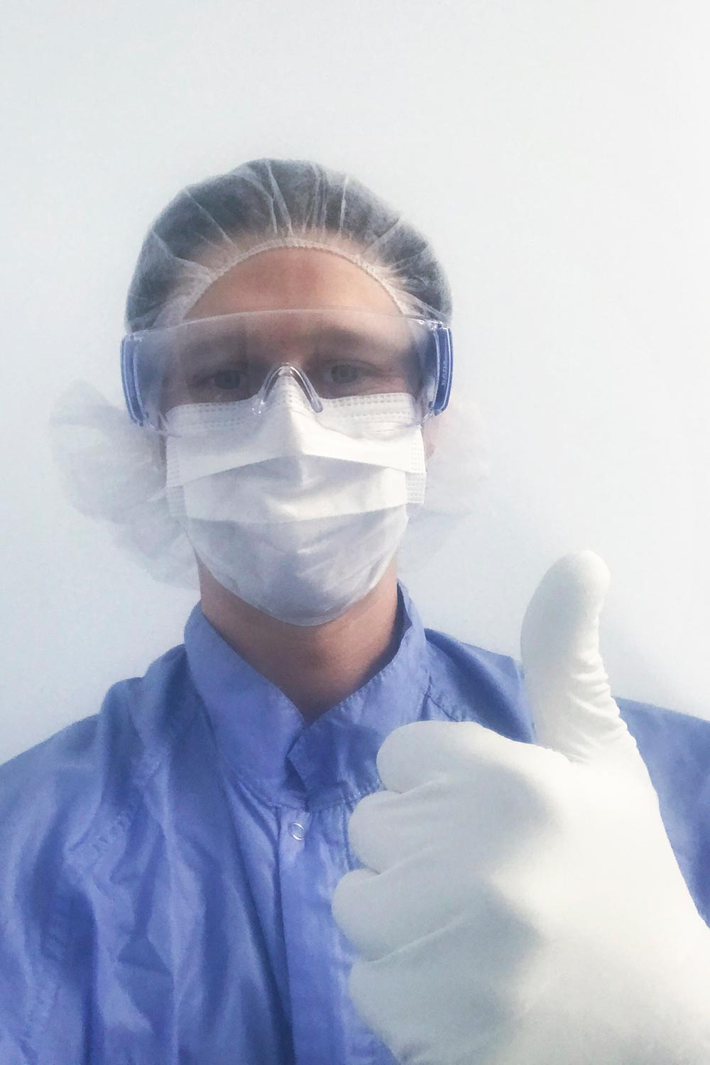 Nicholas Seyler headshot with mask, protective eye ware, and hair net