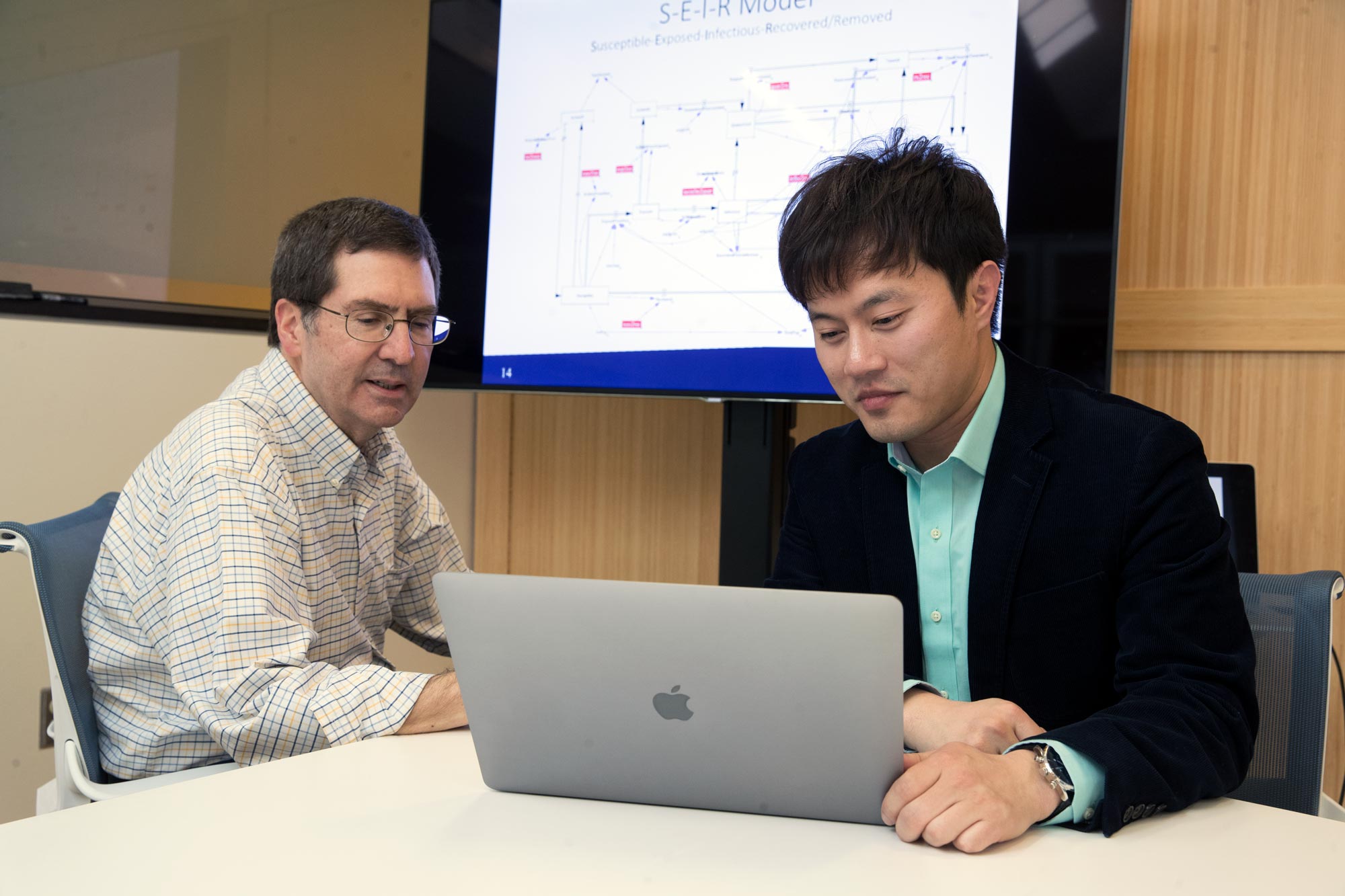 Myung and senior engineer Andy Ortiz, left, working on a computer toghether
