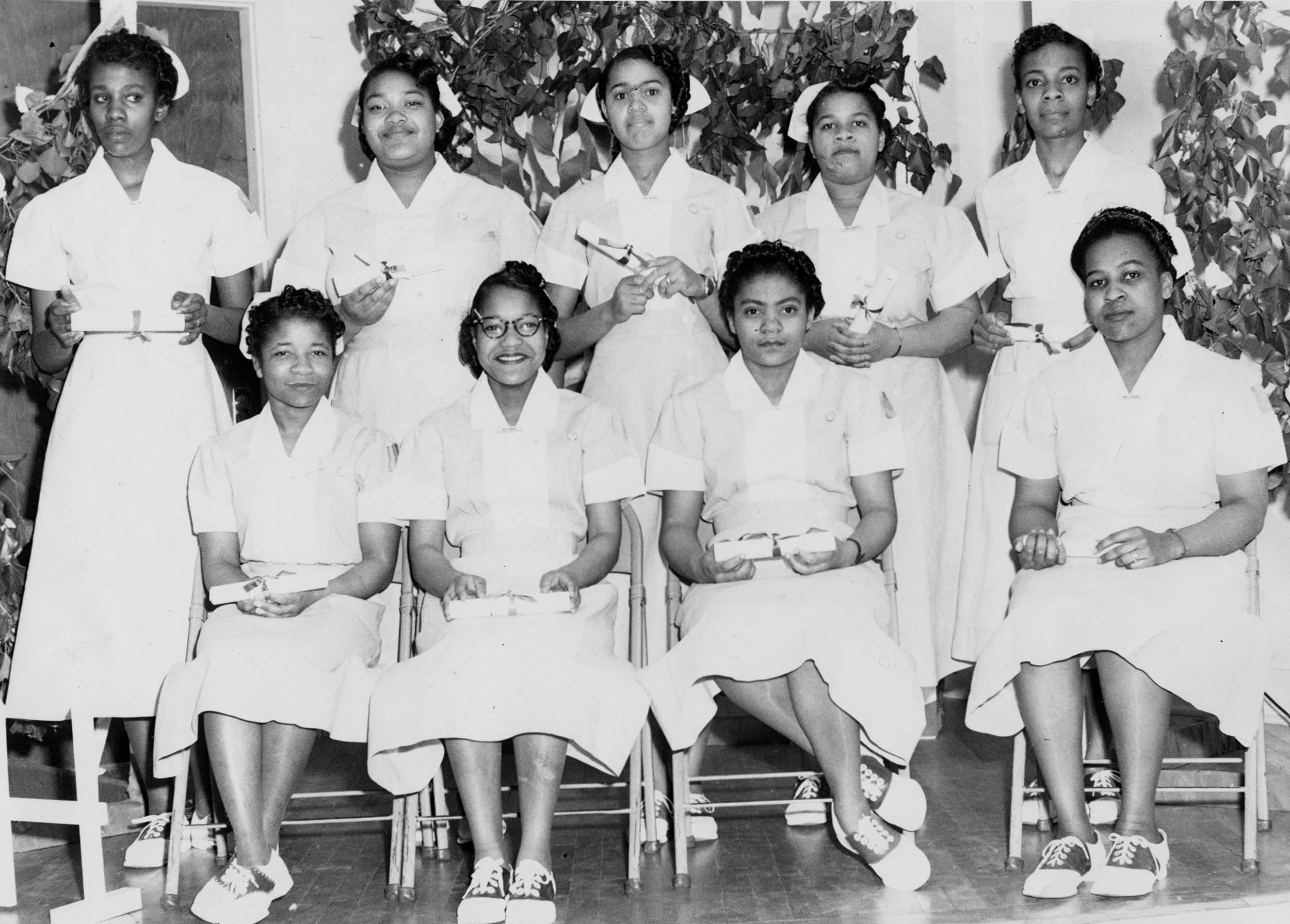 Group photo of 9 African American Nurses with their diplomas