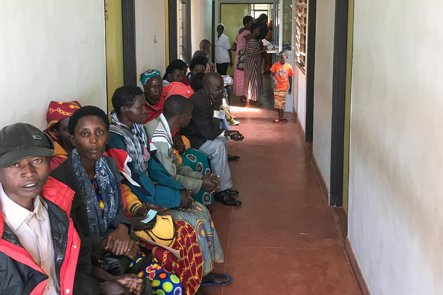 People in Rwanda lined a hallway waiting to be seen by a doctor