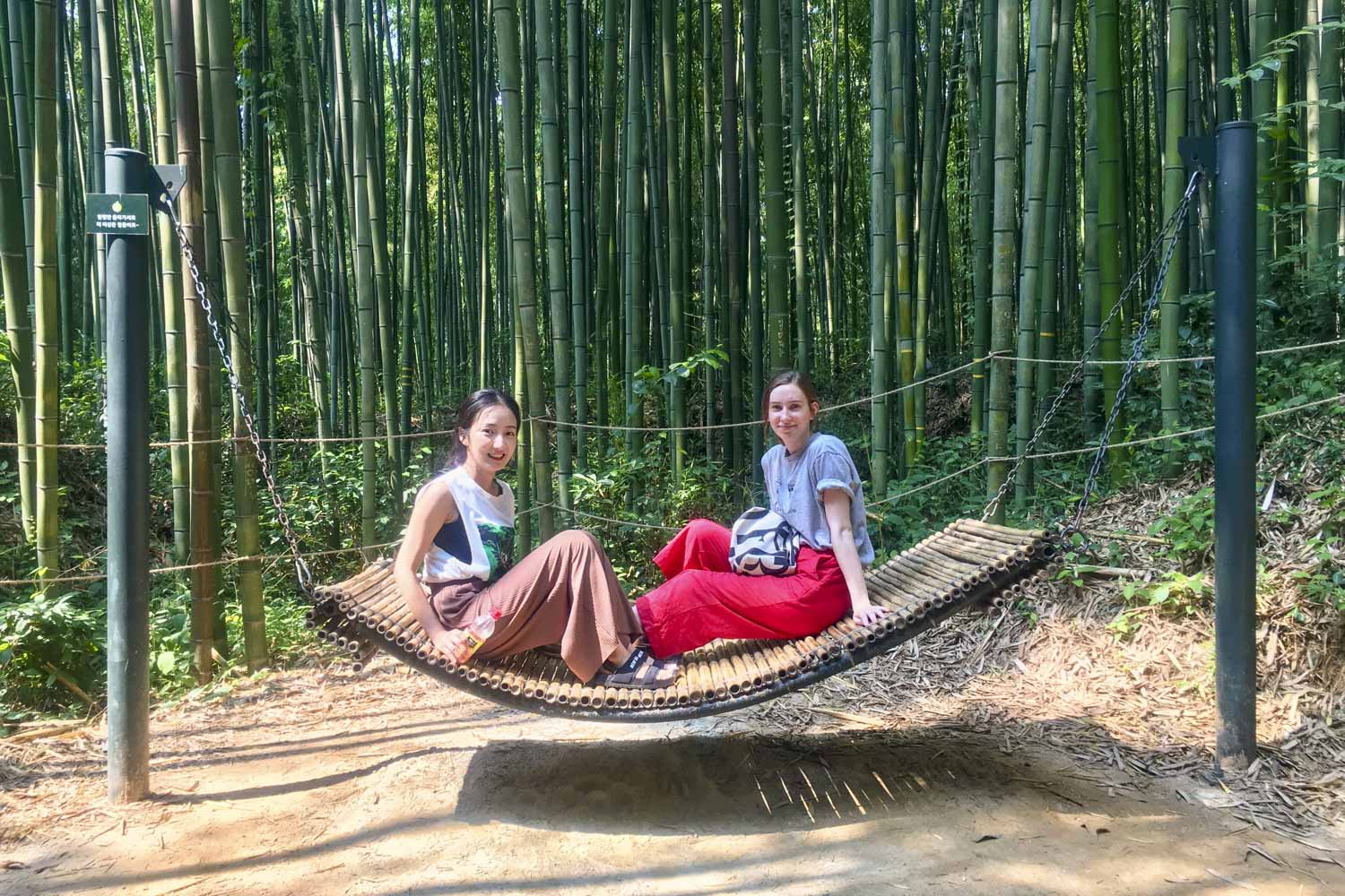 Olivia Grotenhuis (right) relaxes with Yoo Hyang (left) in a bamboo hammock