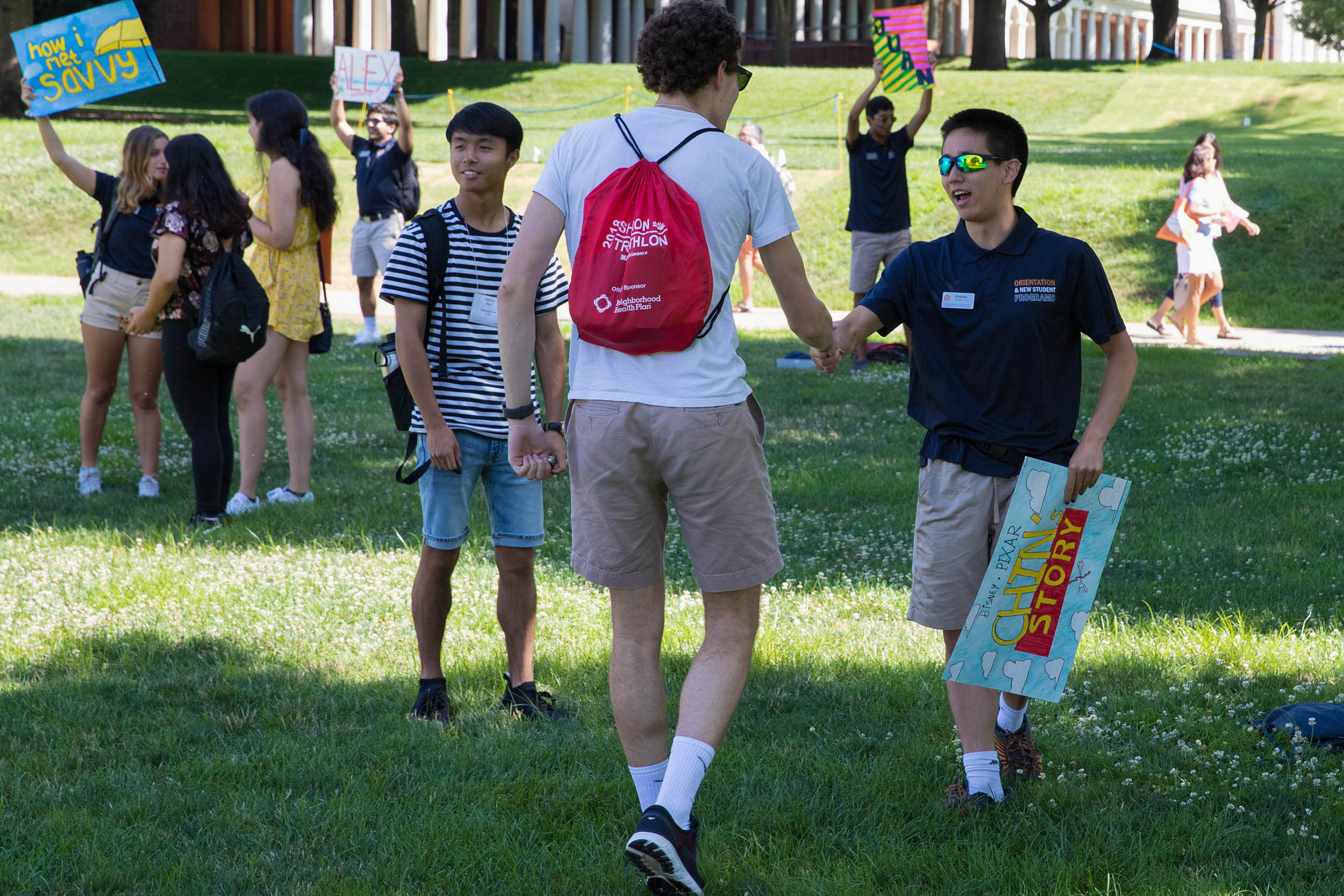 Students shake hands on the lawn during orientation 