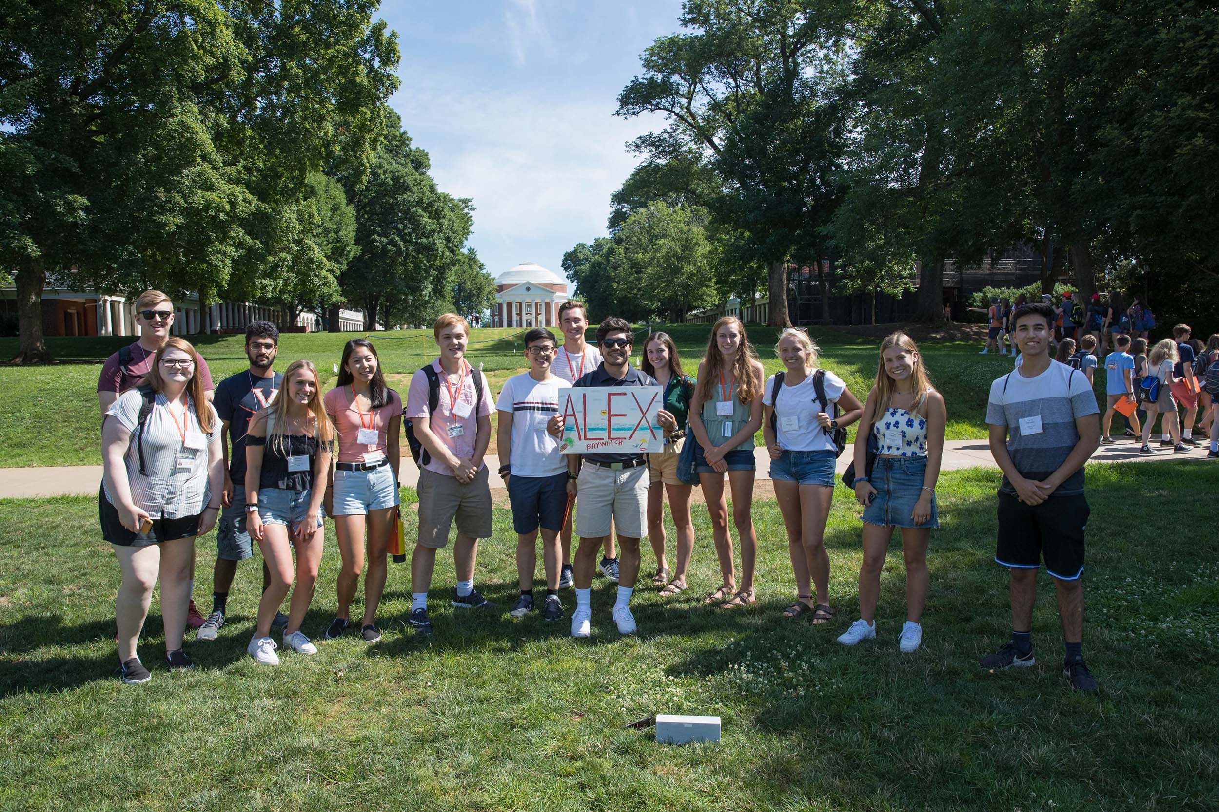 Alex holds a sign with his orientation group