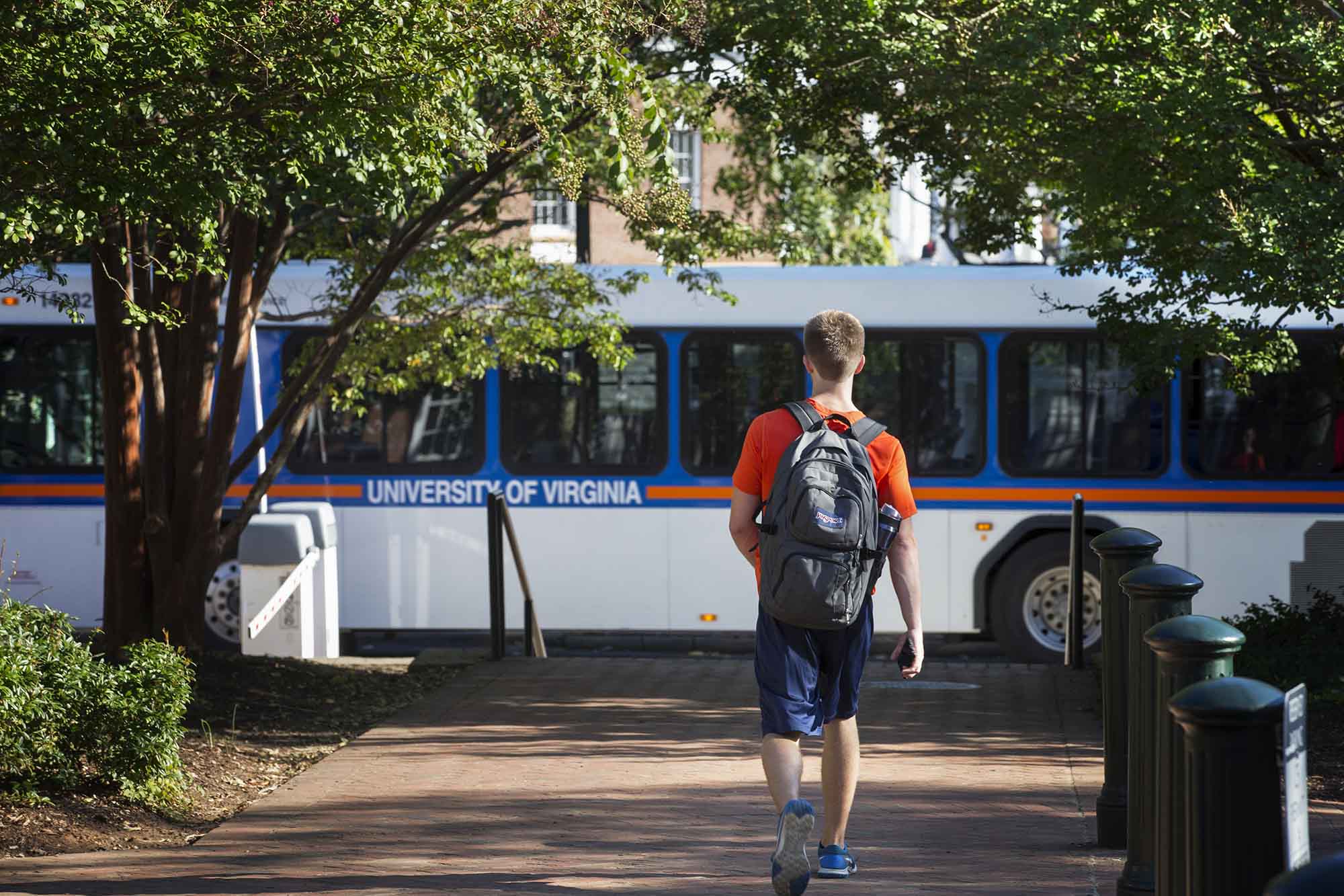 Student walks to a UVA bus