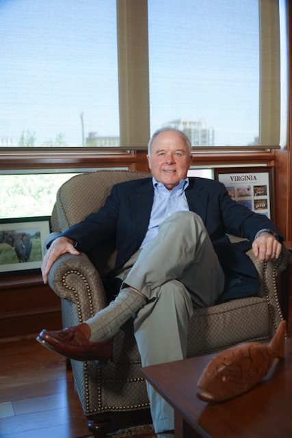 Paul Manning sitting in a chair smiling at the camera