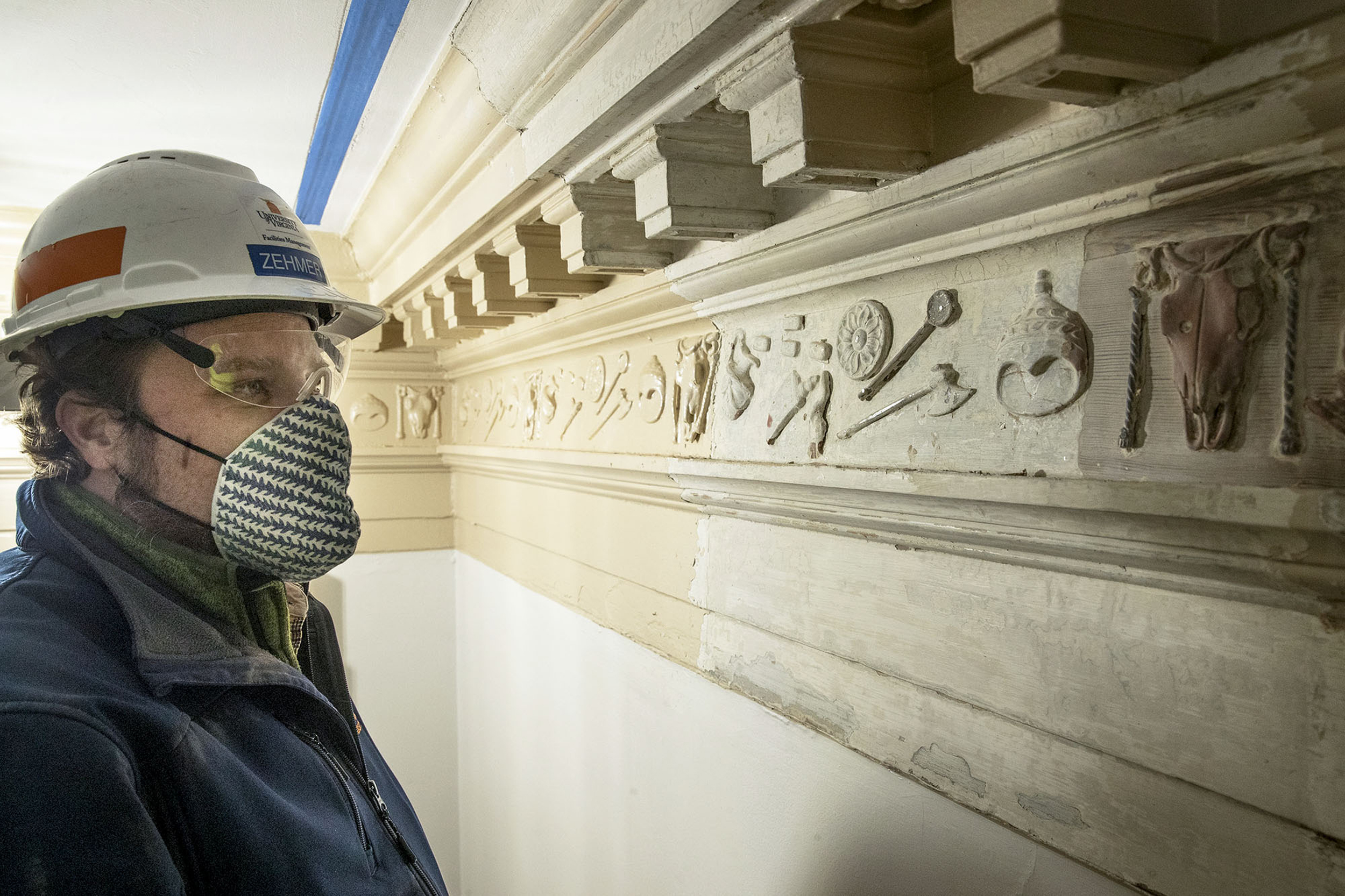 James Zehmer inspects the entablature that has intricate designs on it