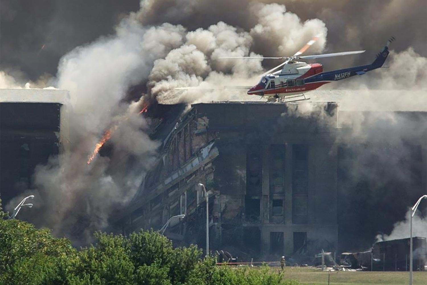 Water Helicopter flying at the Pentagon as fire and smoke come out of it