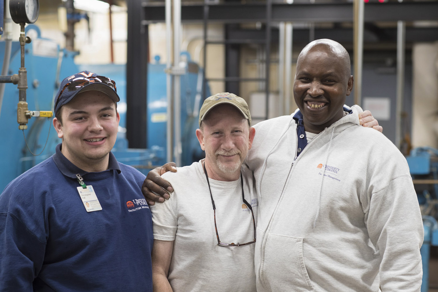 Chege, right, with Christopher Hall, left, and  Bill Kardos smiling at the camera