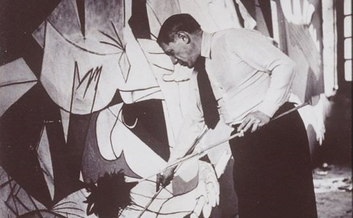 Picasso painting “Guernica” in Paris in May of 1937. 