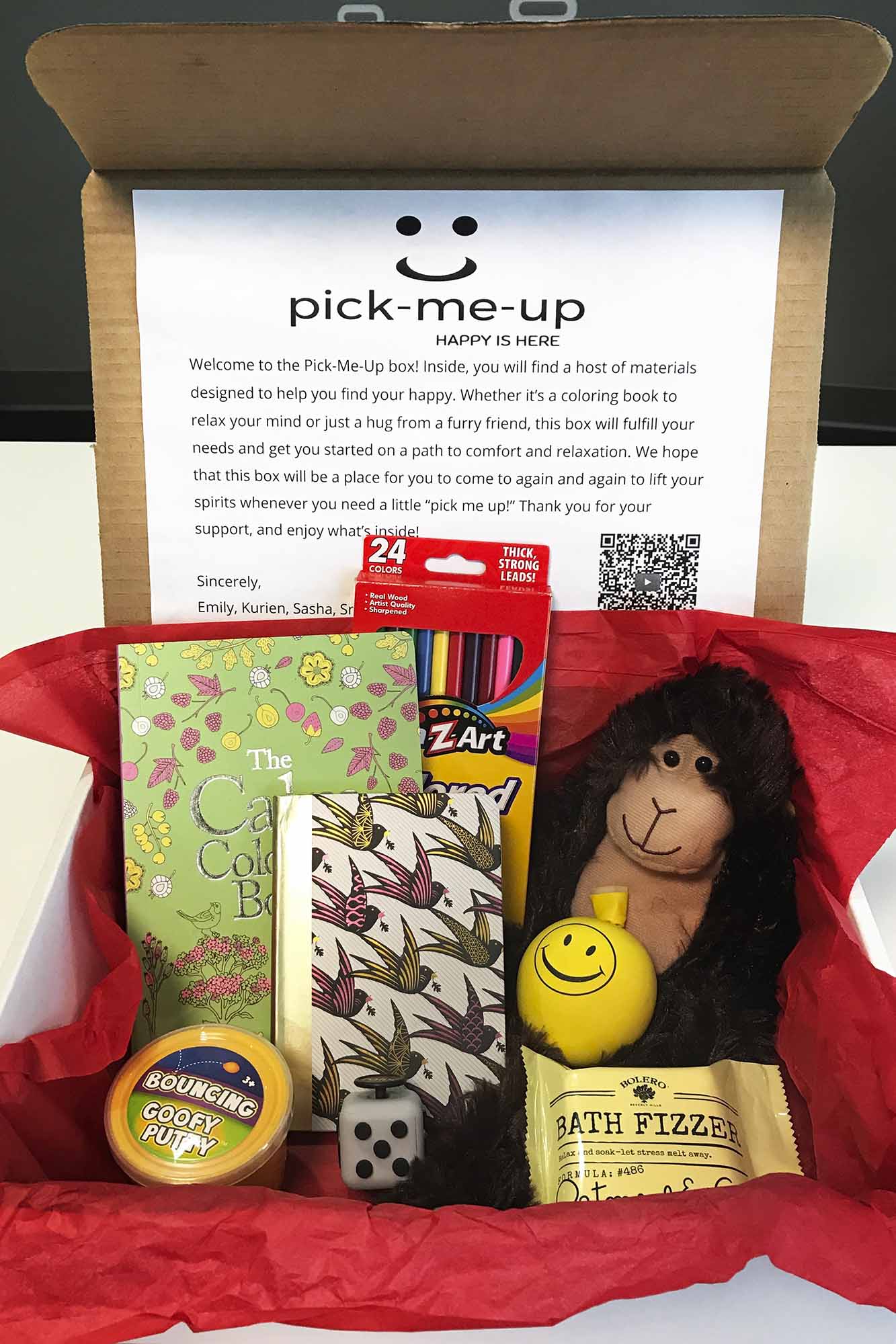 Box filled with stuffed animals, colored pencils, and coloring books