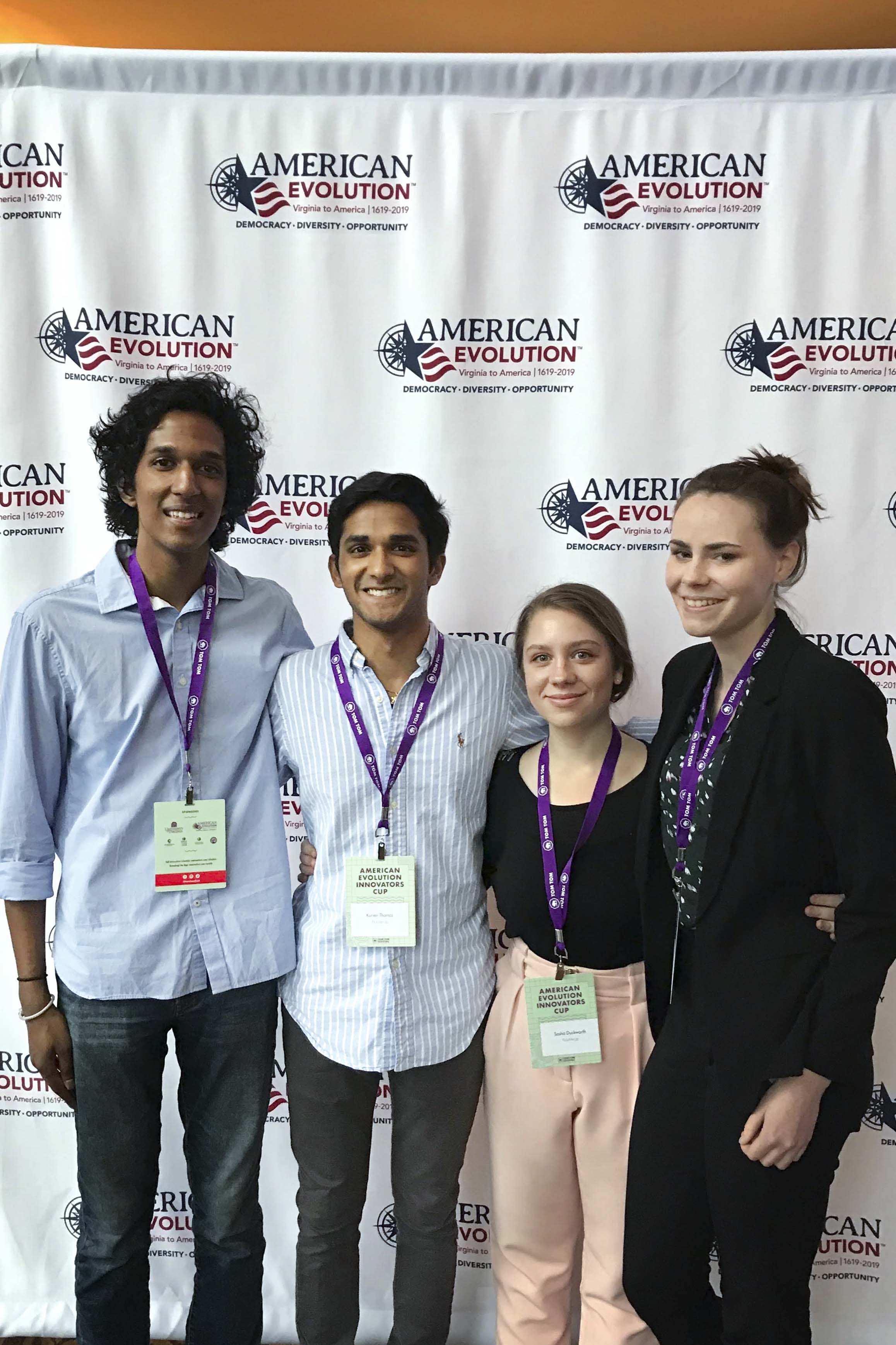 Kurien Thomas, second from left and Sasha Duckworth, second from right stand for a group photo with two other people