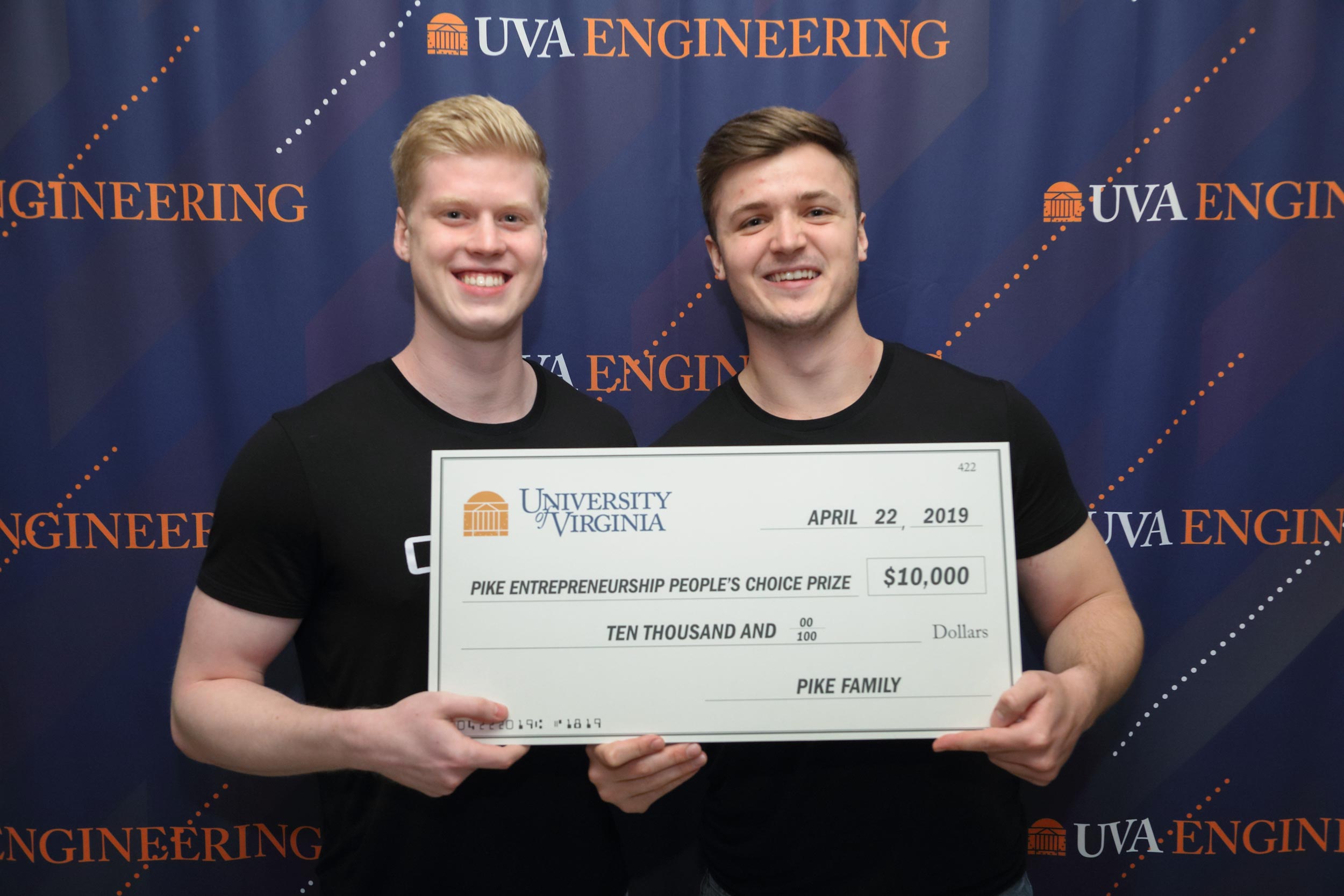 Conner Huston, left, and Parker Hamlin hold a check for ten thousand dollars