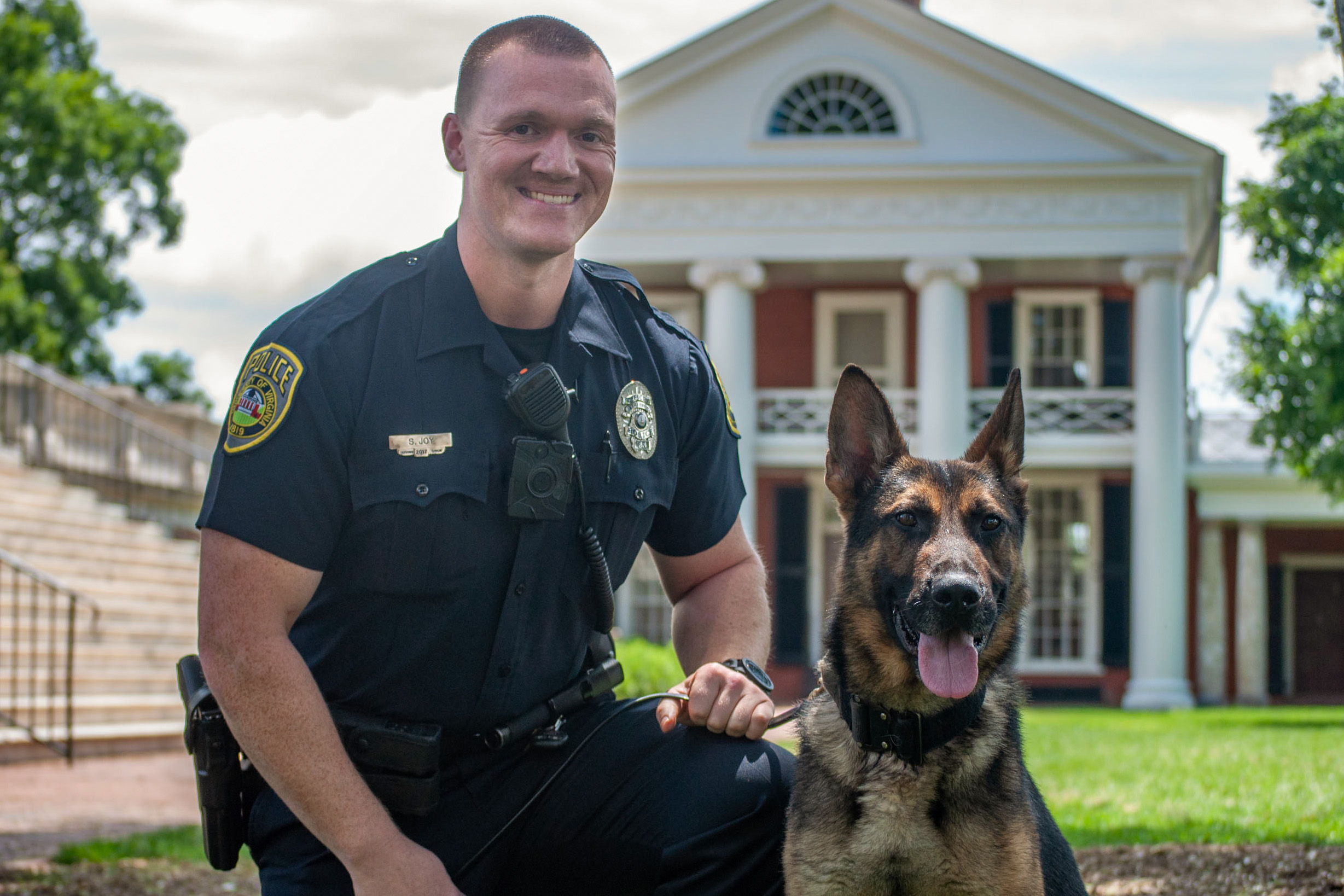 Officer Joy and Rexo pose for the camera.