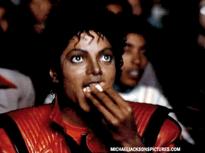 Michael Jackson eating popcorn watching a screen