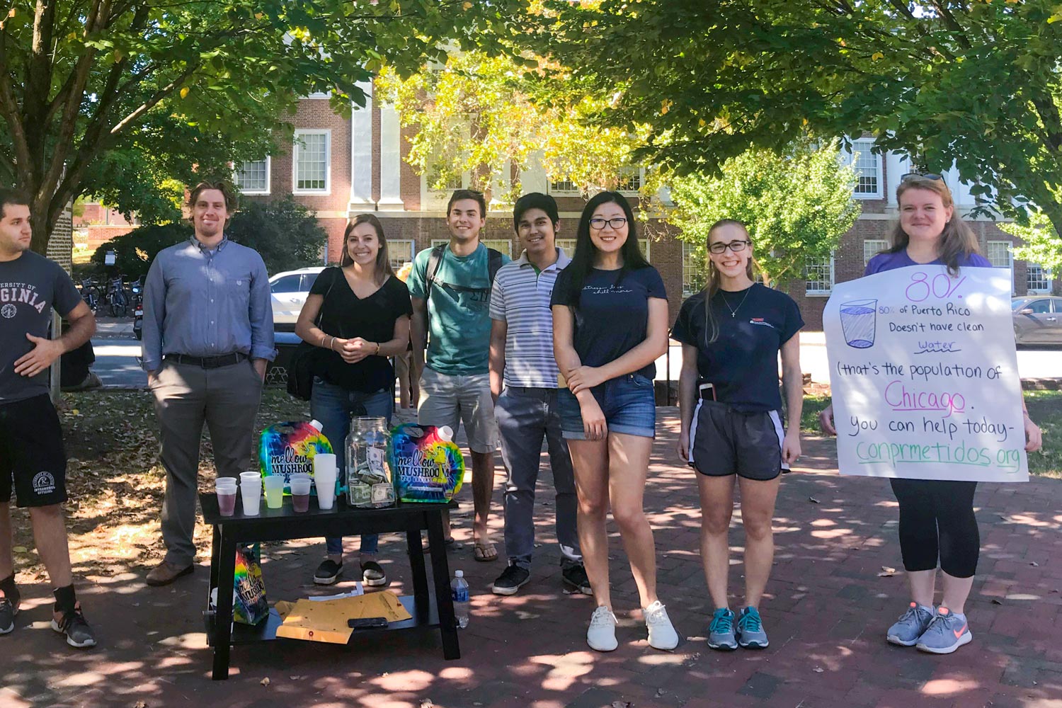 Batten School students stand at a fundraiser event