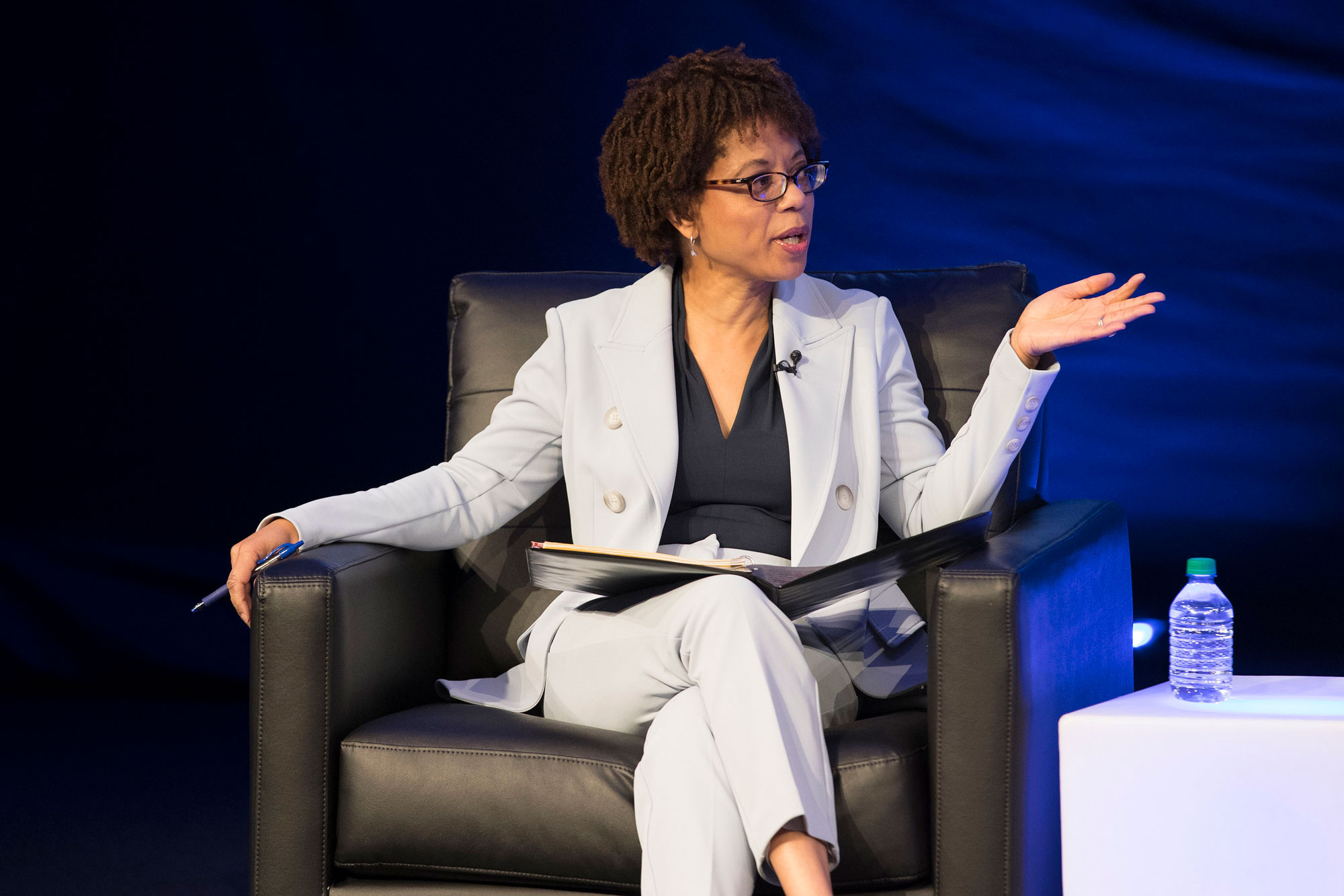 Melody Barnes talks to panelists on stage