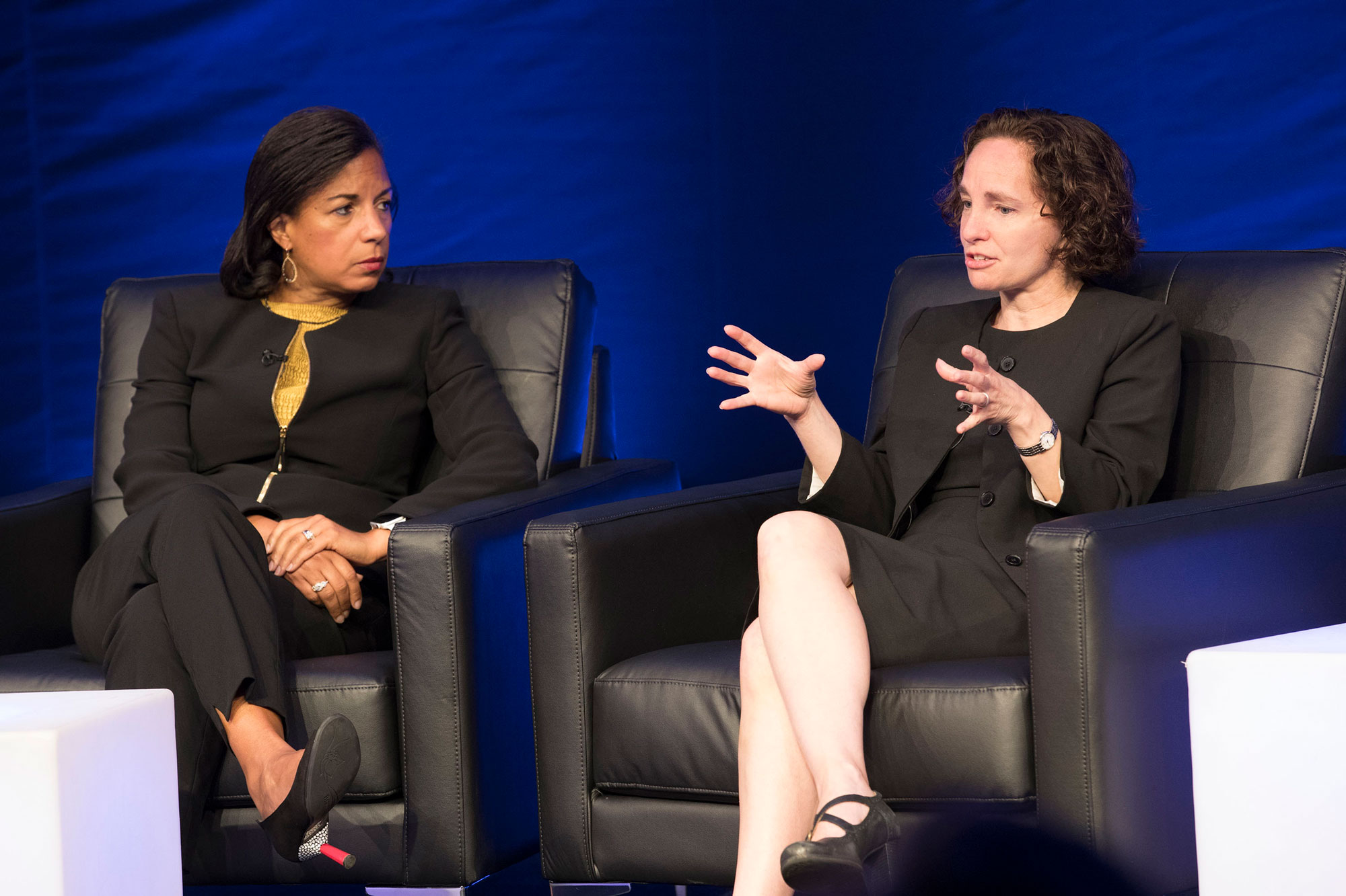 Susan Rice, left, and  Risa Goluboff sit in chairs on stage talking to a crowd