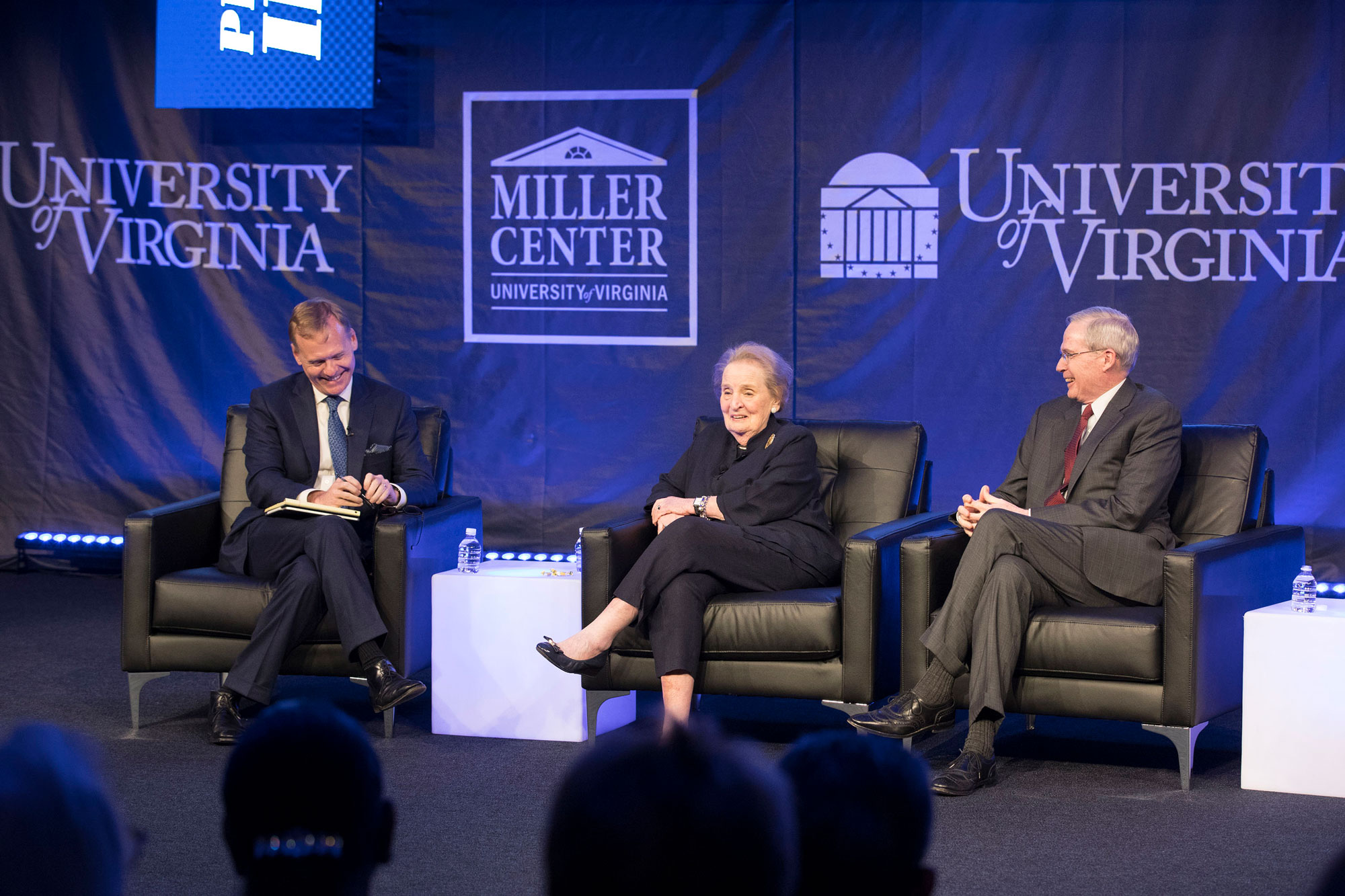 Panelists laughing on stage Madeleine Albright, center, Stephen Hadley, right, and John Dickerson