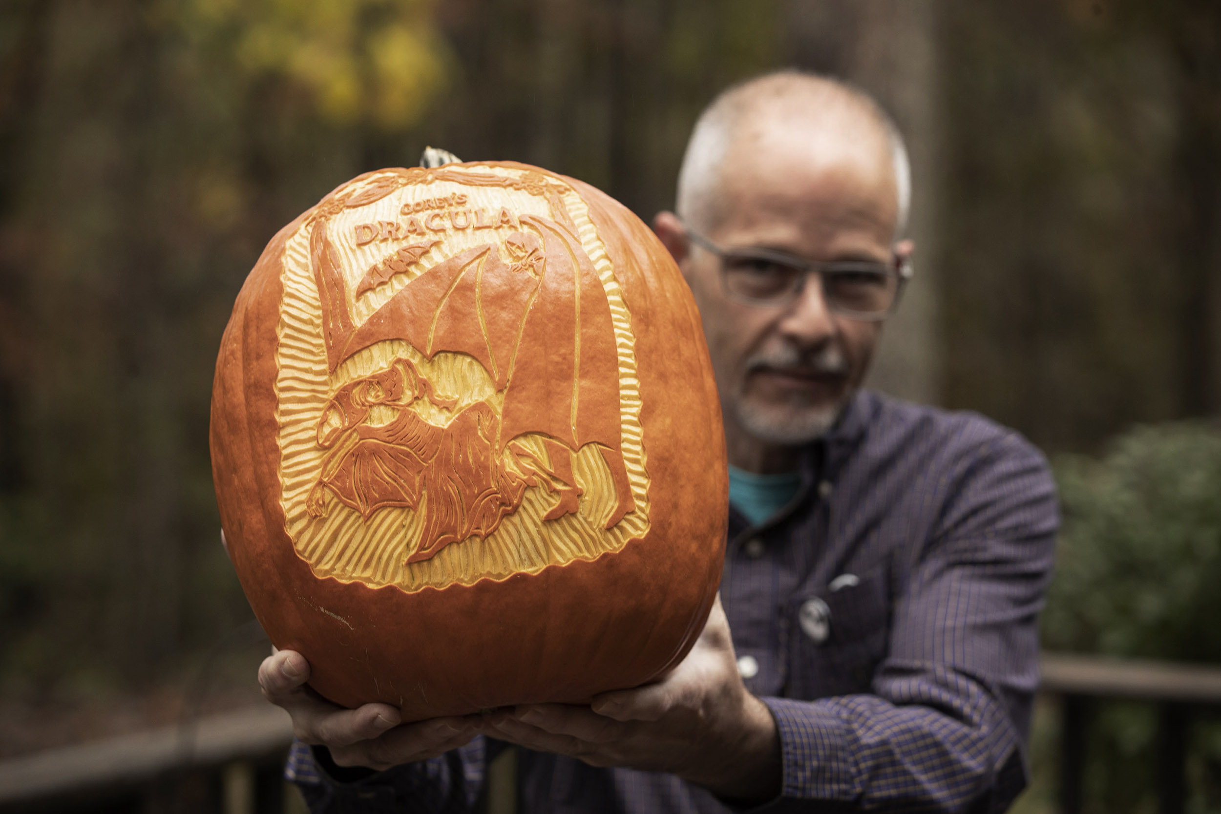 Ed Morton holds his Dracula carved pumpkin