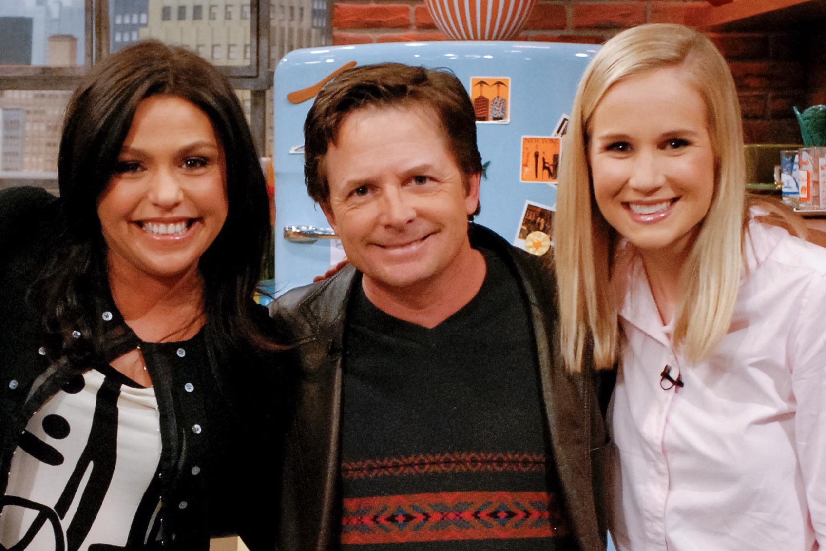 Rachael Ray, left, featured Mary Yonkman, right,  Michael J. Fox, center pose together for a picture