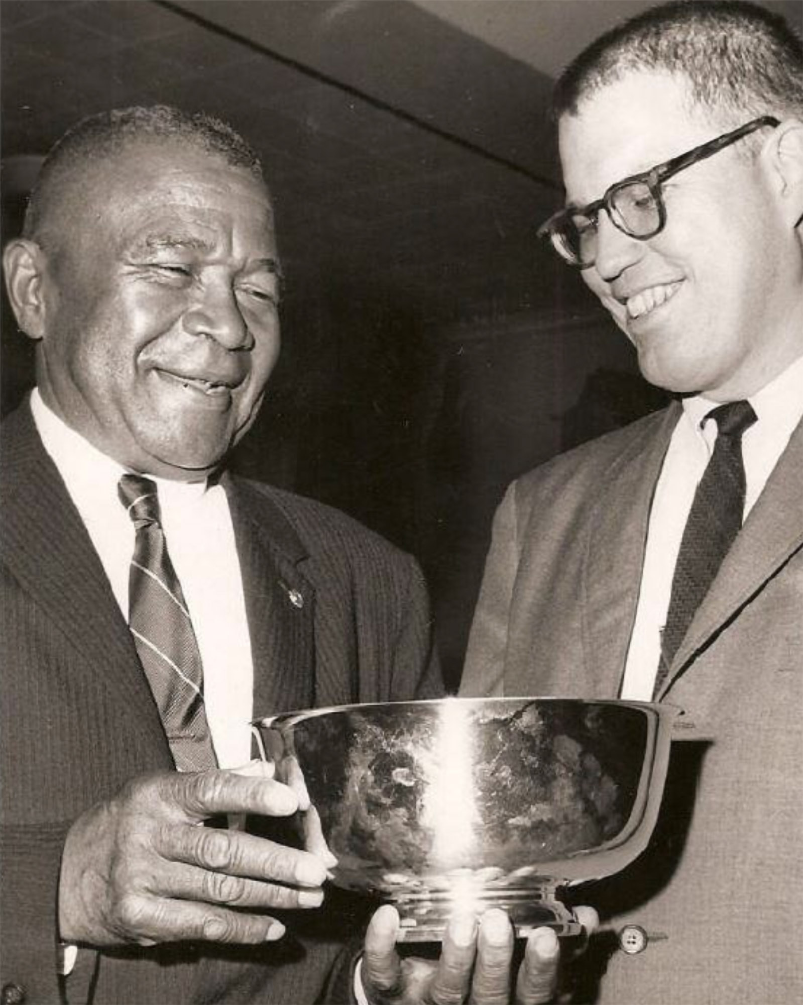 Randolph Lewis White, left, holding a medal cup with another man